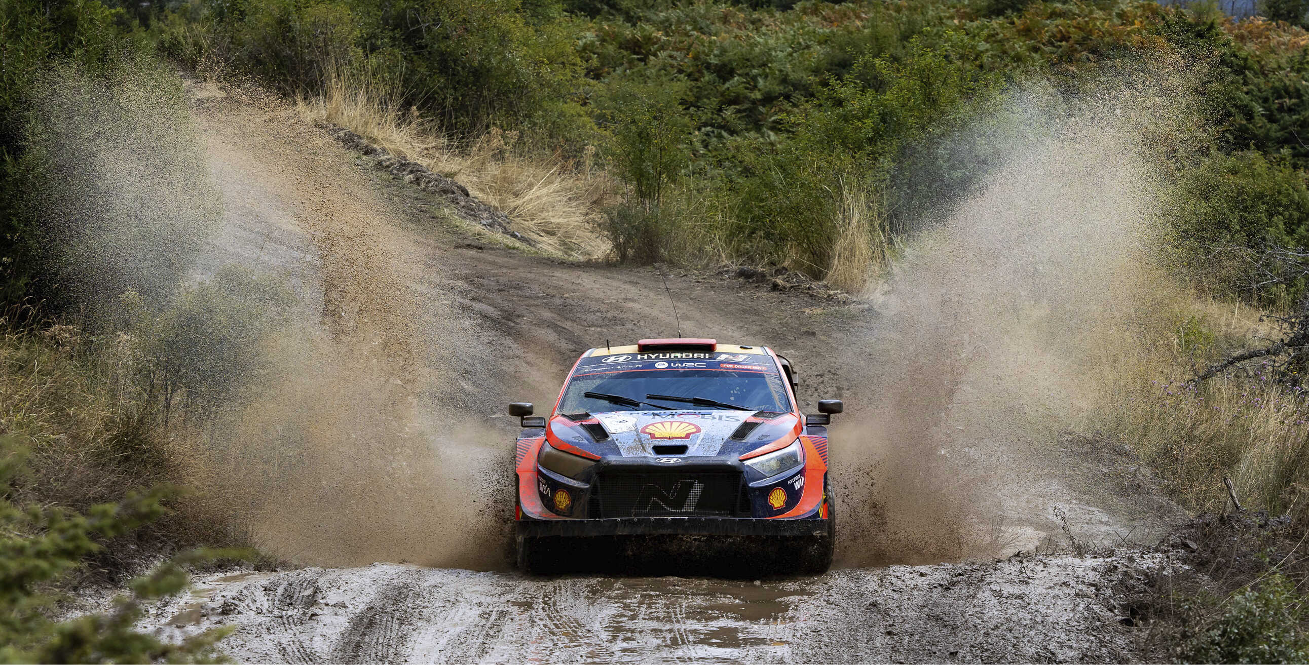 Hyundai rally car in motion on a rough road