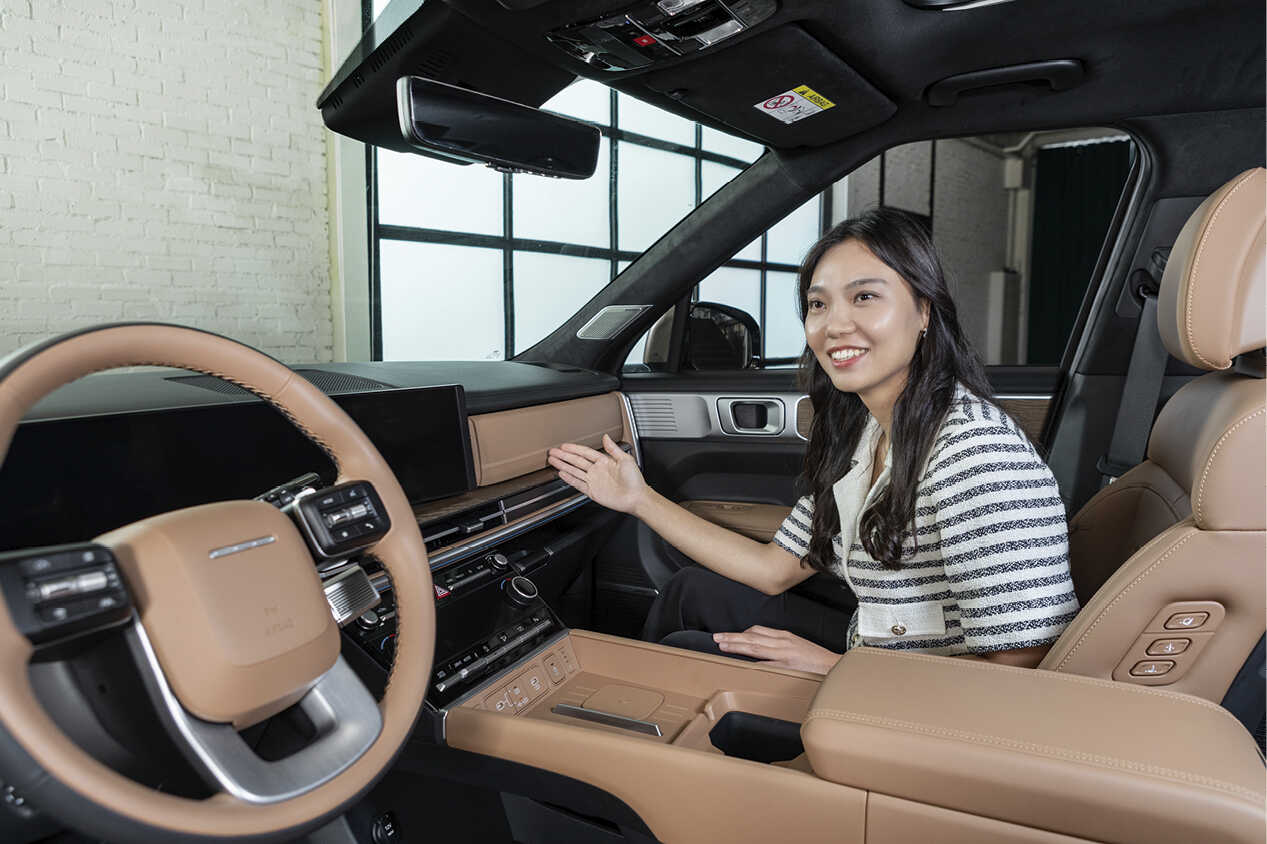 A CMF designer sitting in the passenger seat of the Hyundai The All New Santa Fe.