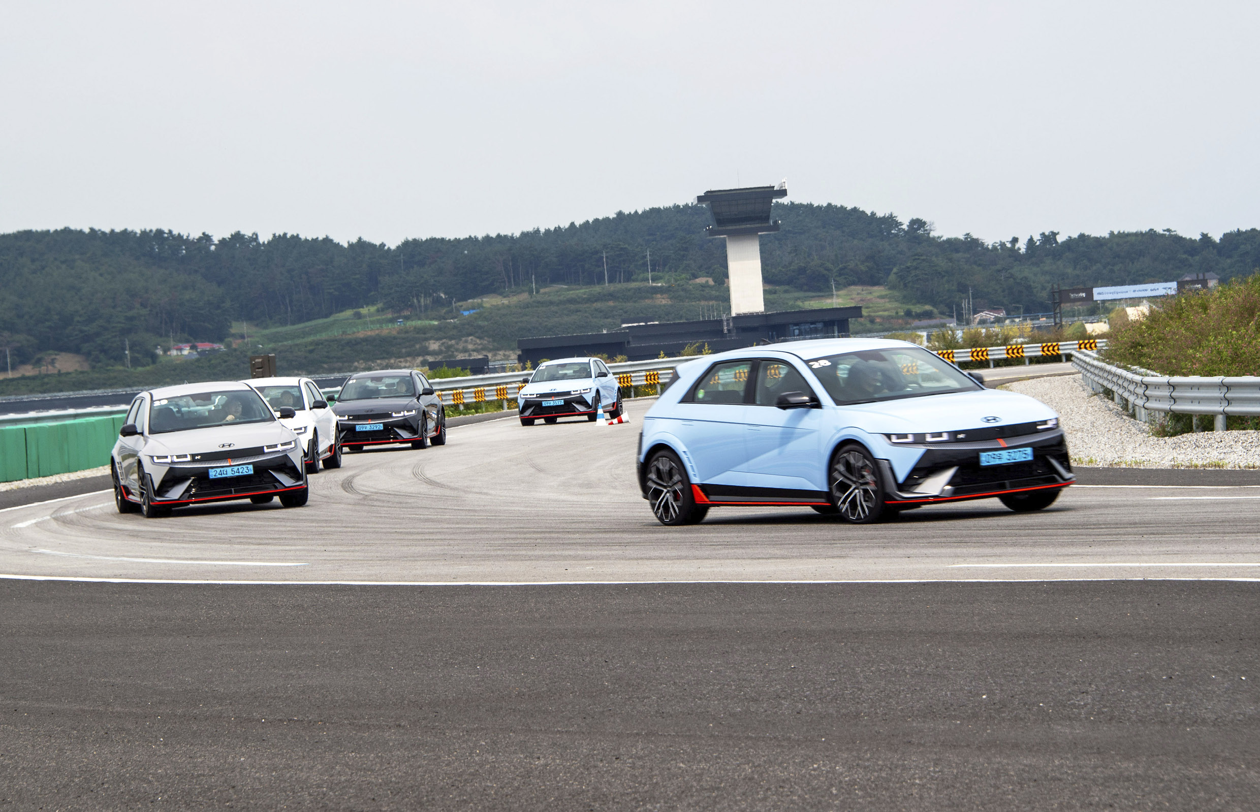 Several IONIQ 5 N vehicles driving on a track as a group