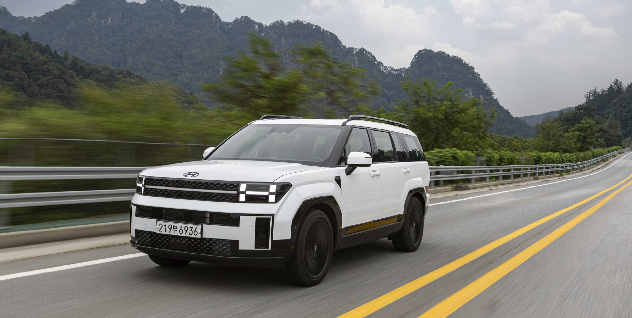 The front of The All New Santa Fe running on a straight road