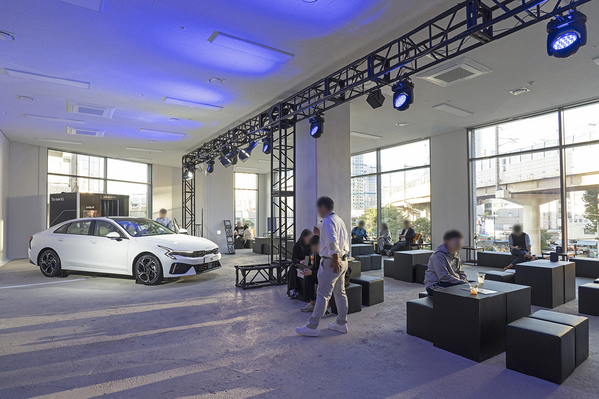 더 뉴 K5 주변으로 관람객이 앉아 있는 모습