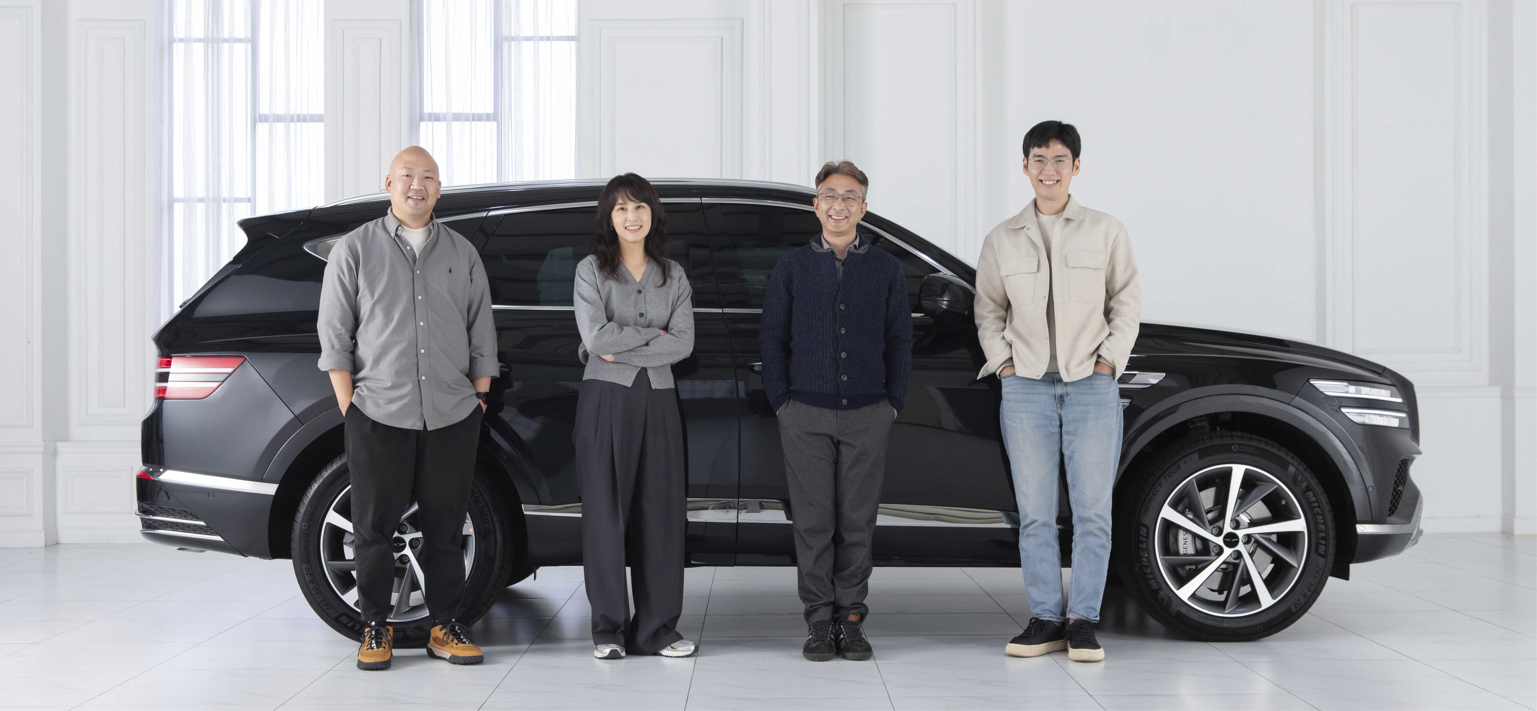The four designers who designed Genesis' new GV80 are standing next to the GV80