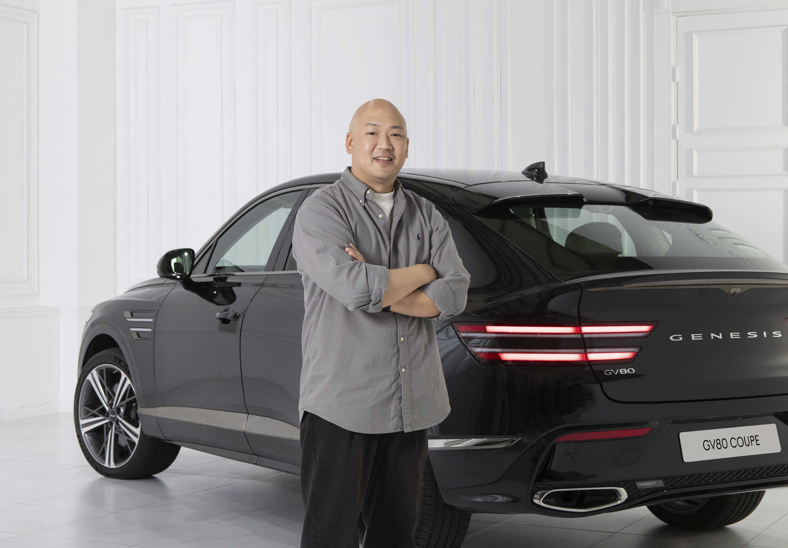 Senior researcher Soorak Hwang posing with the Genesis GV80 Coupe in the background