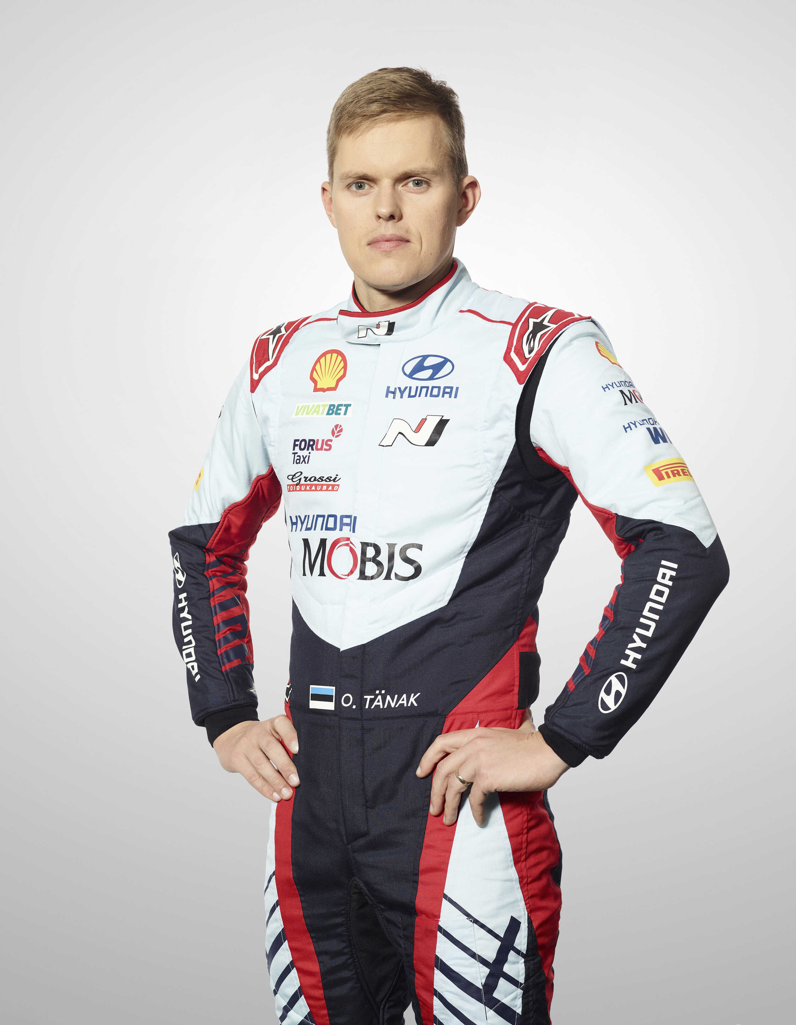 Profile photo of Ott Tanak looking straight ahead with his arms supported on his pelvis