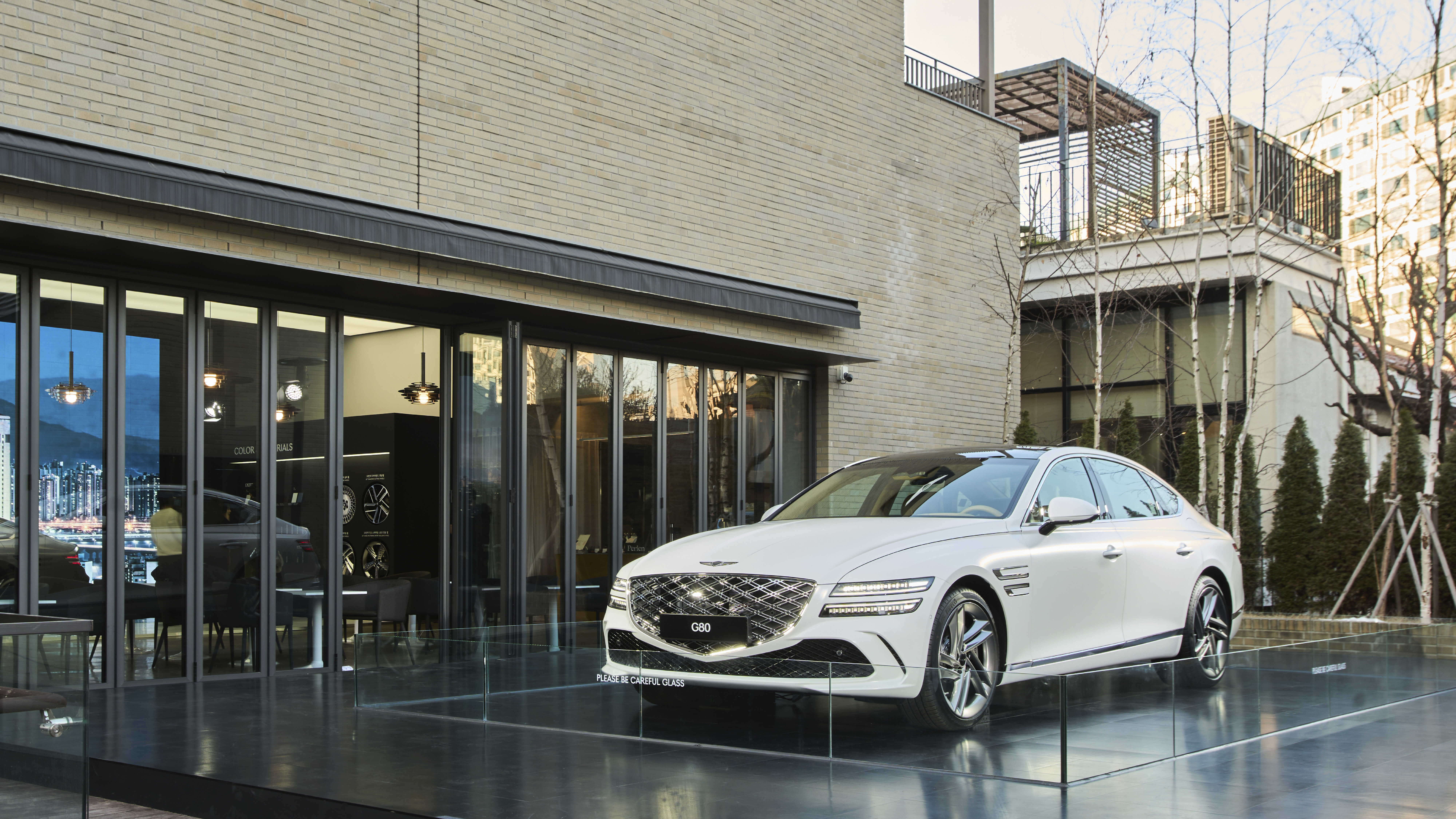 A white G80 standing in front of the exhibition hall