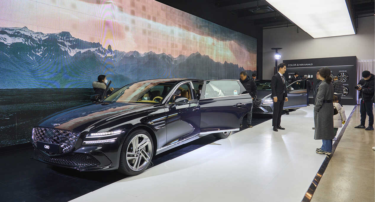 Visitors looking at various parts of the G80 in the exhibition hall