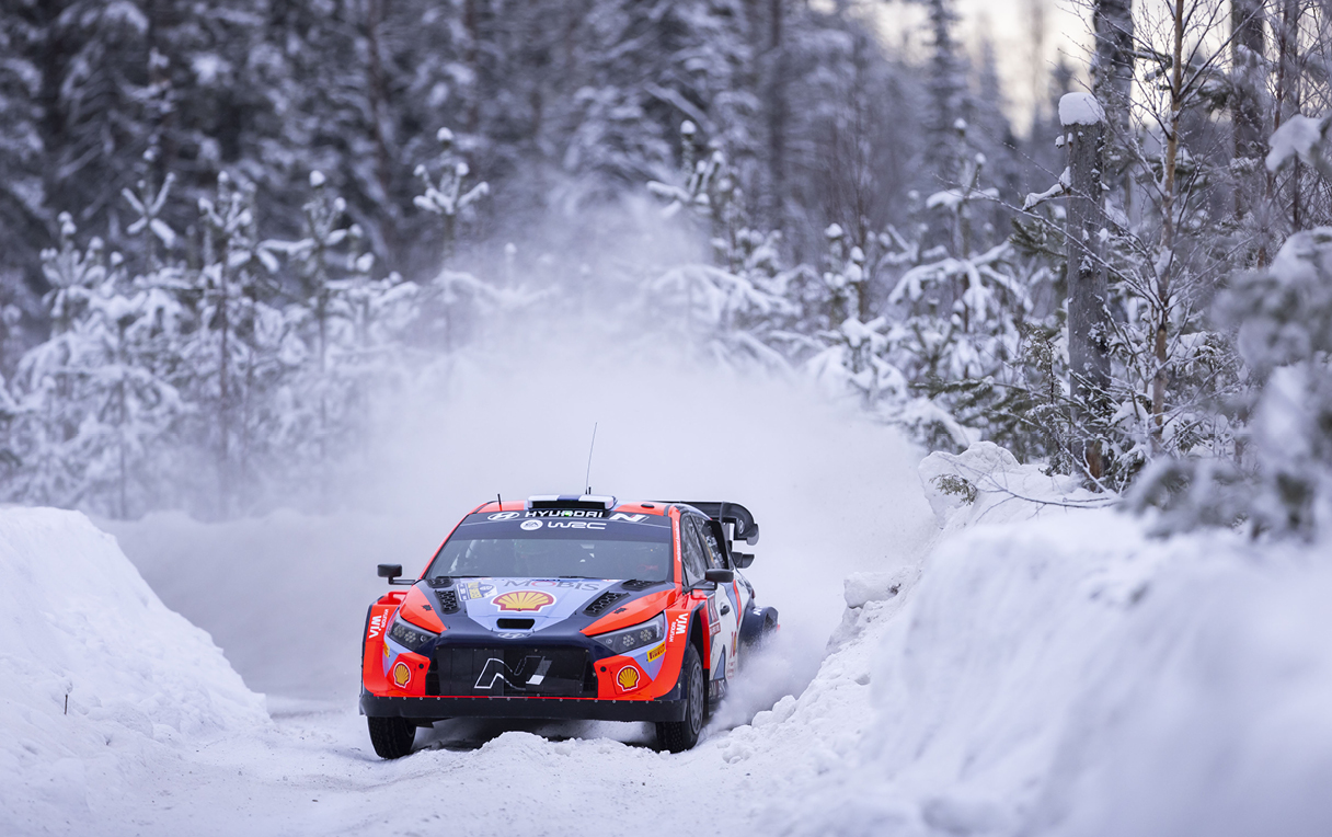 Rally car running on a snow-filled road