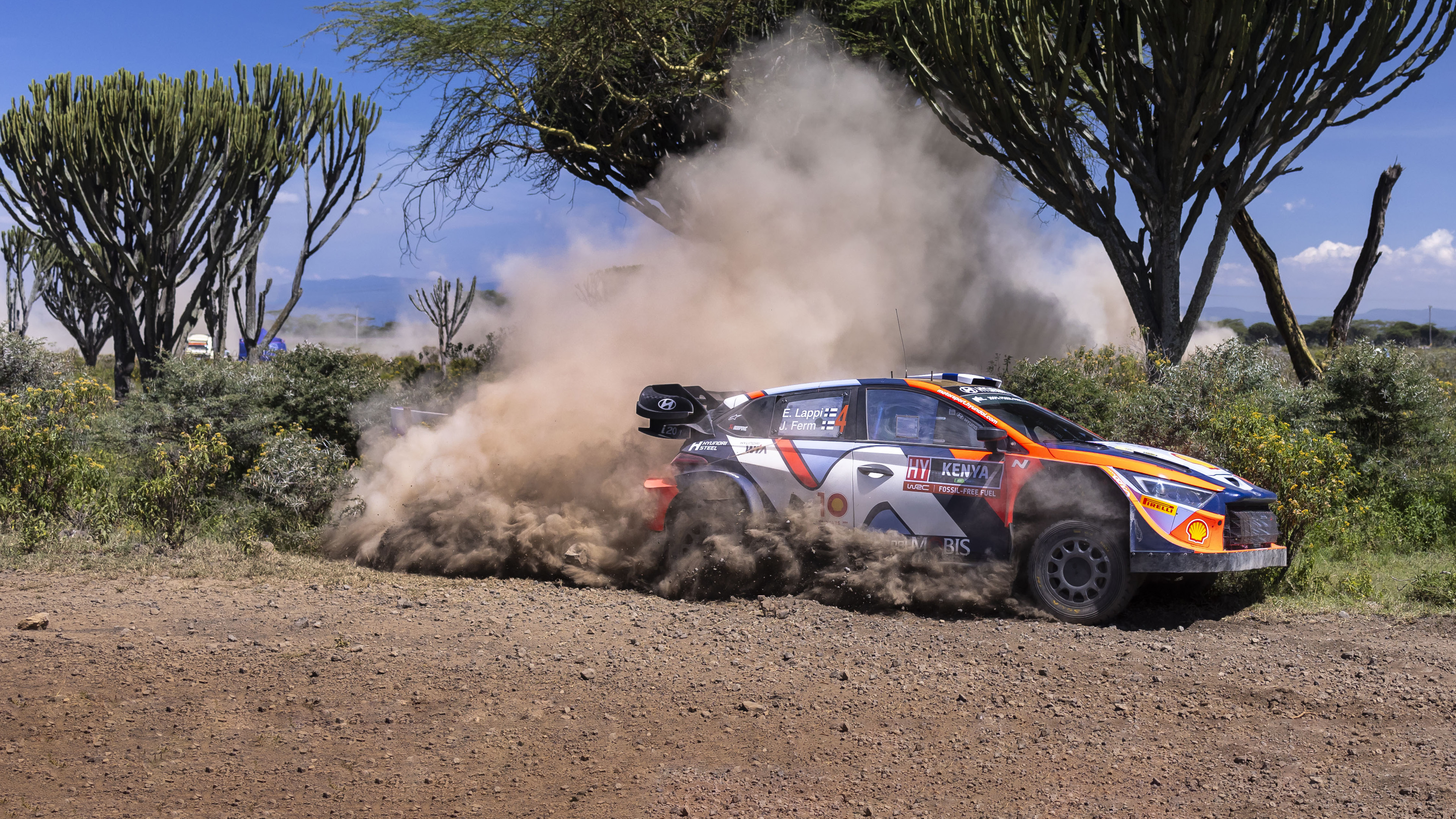 a rally car running down a hill