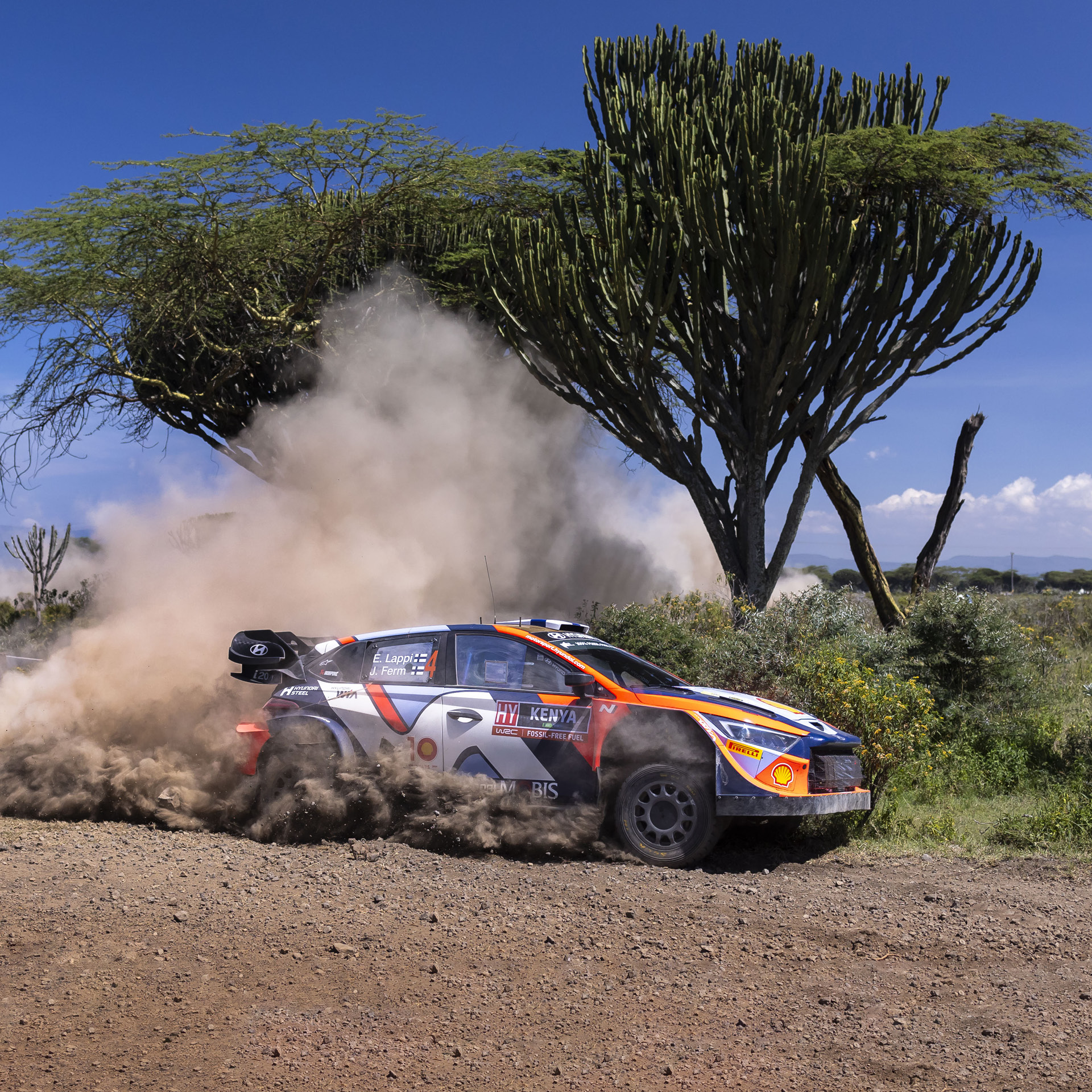 a rally car running down a hill