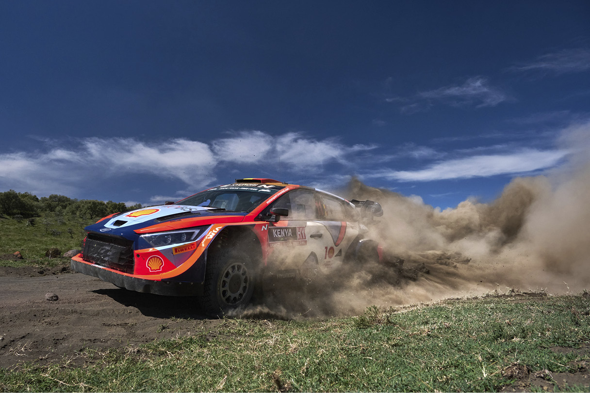 a rally car running down a hill