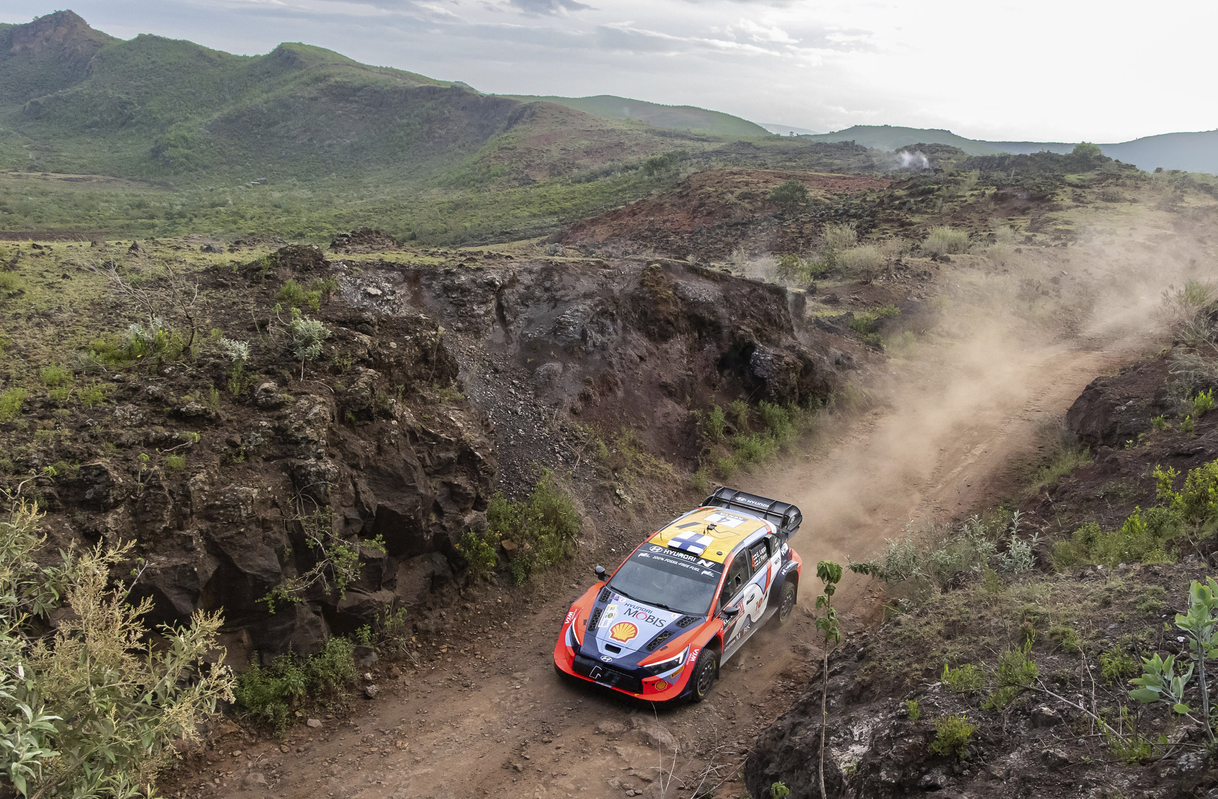 The rally car is running down the hill