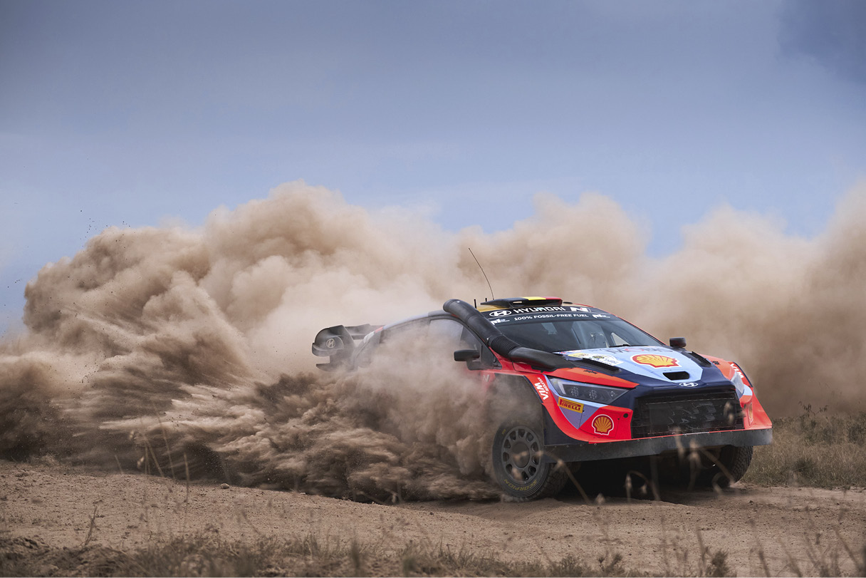 a rally car running through a rough road