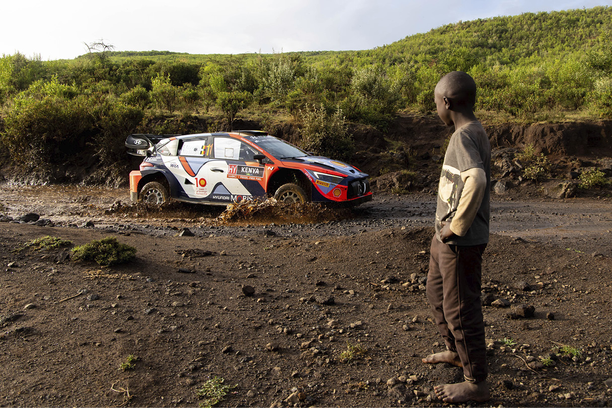the appearance of a rally car running on a muddy road
