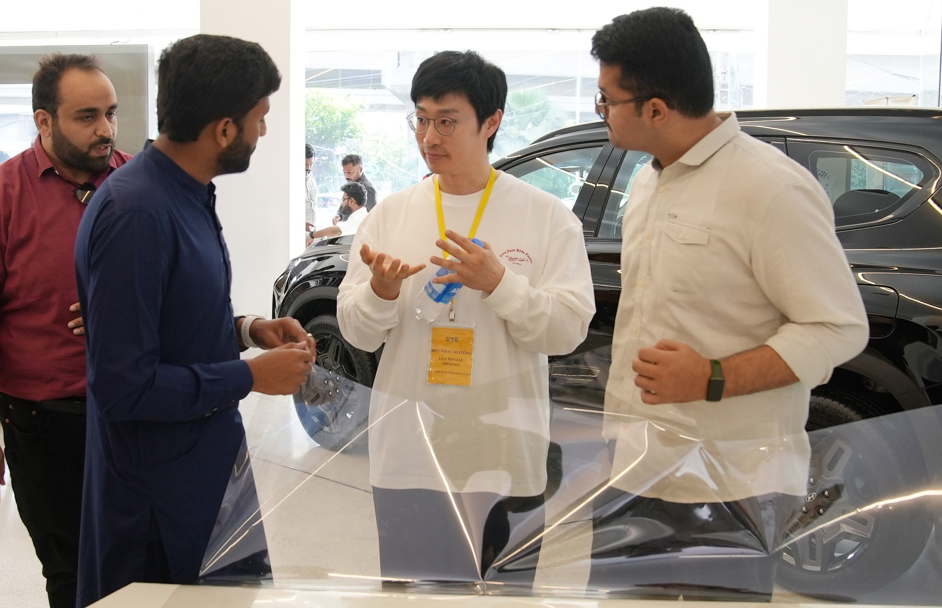 Hyundai Motor Company researcher talking about nano cooling film with a local customer