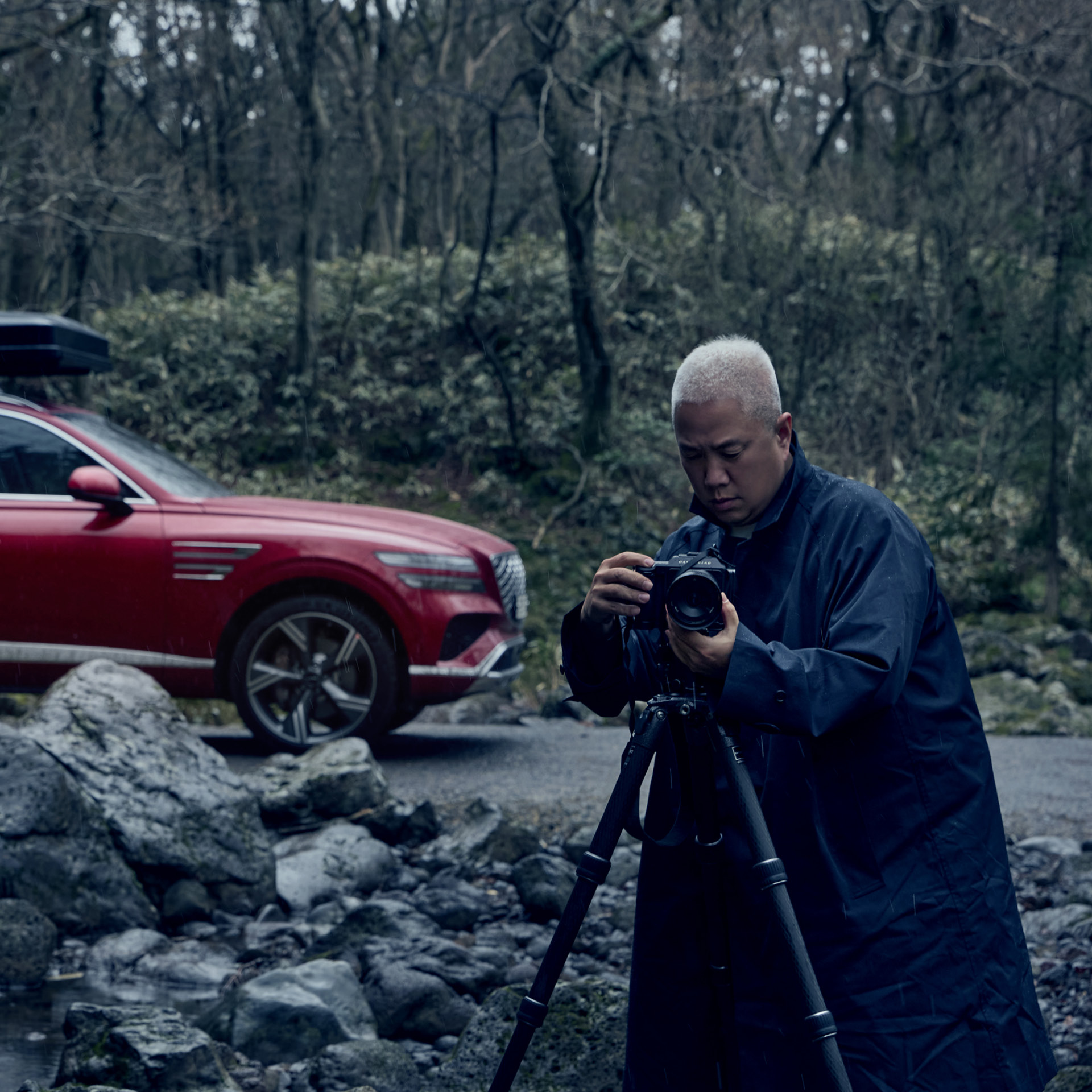 a photographer photographing a car