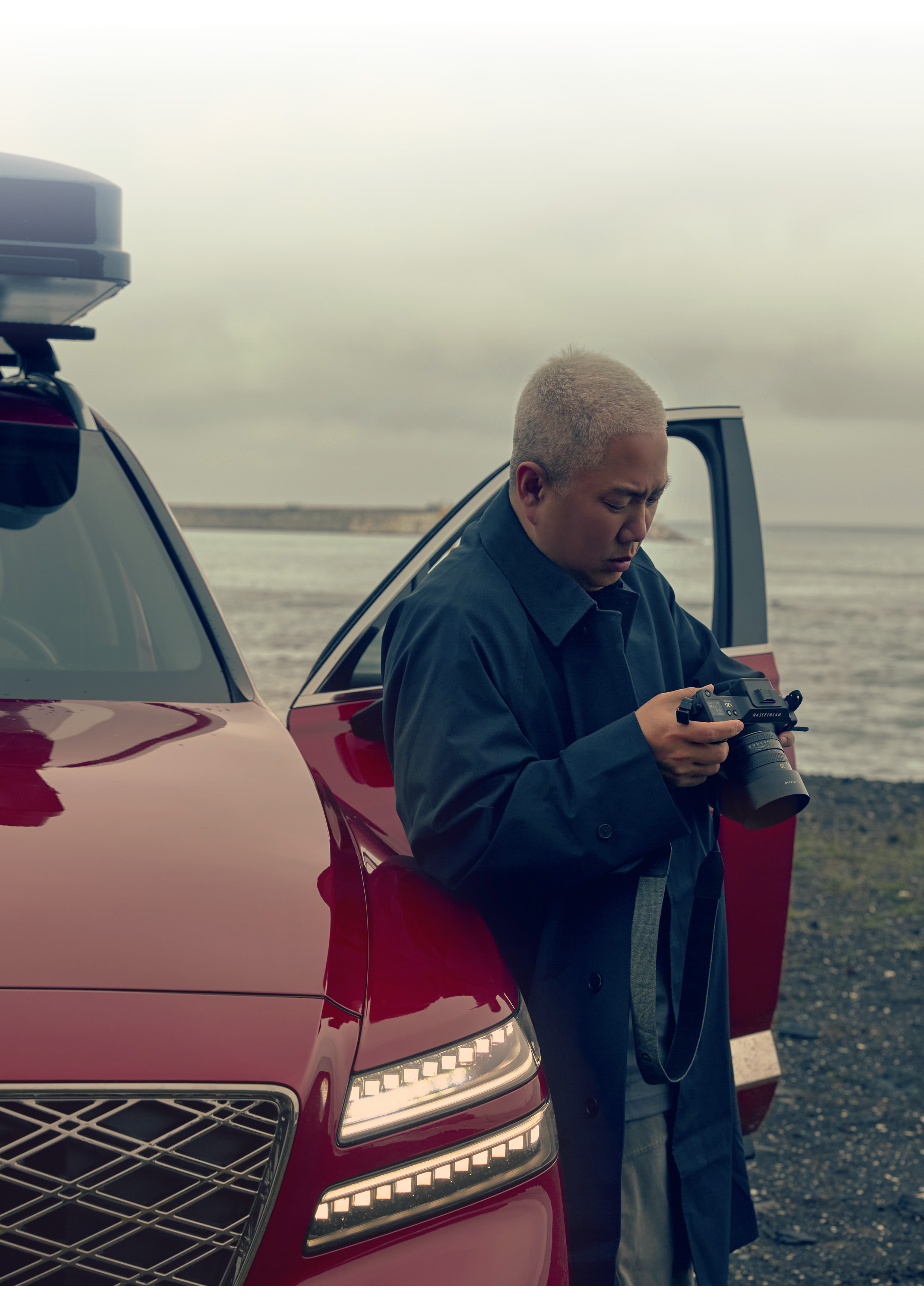 a photographer photographing a car