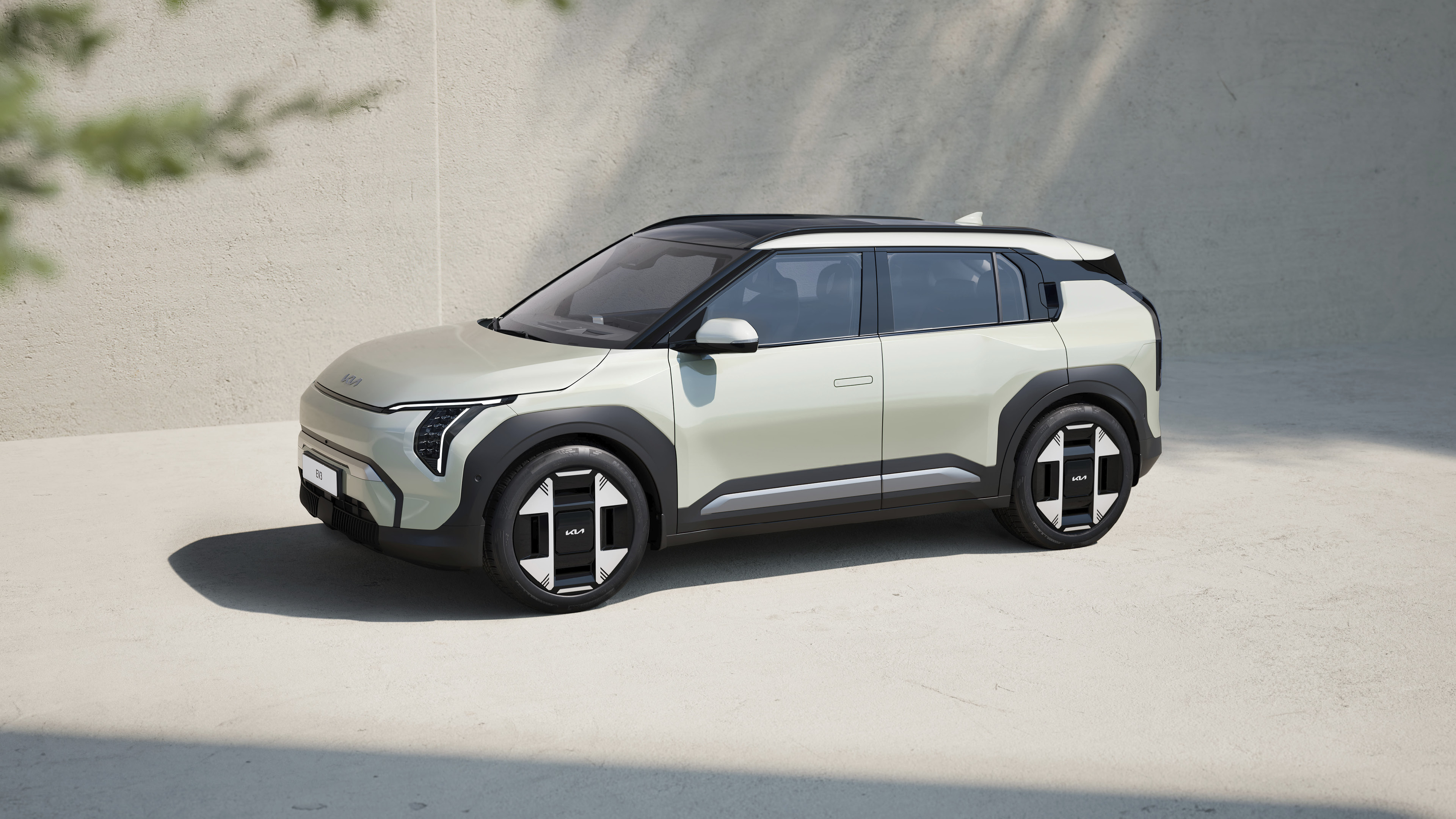 회색 건물과 바닥에 주차된 소형 SUV 전측면 모습