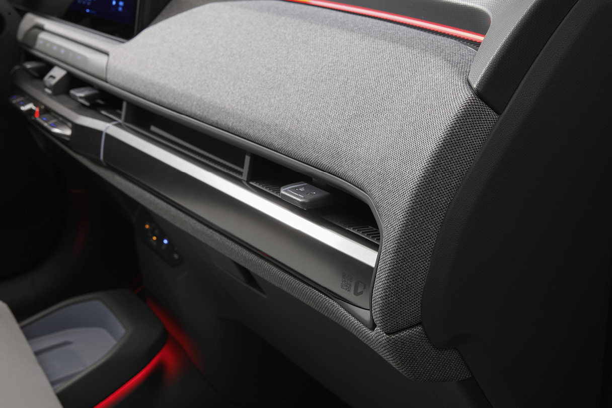 Part of the front passenger seat of EV3 crash pad using fabric