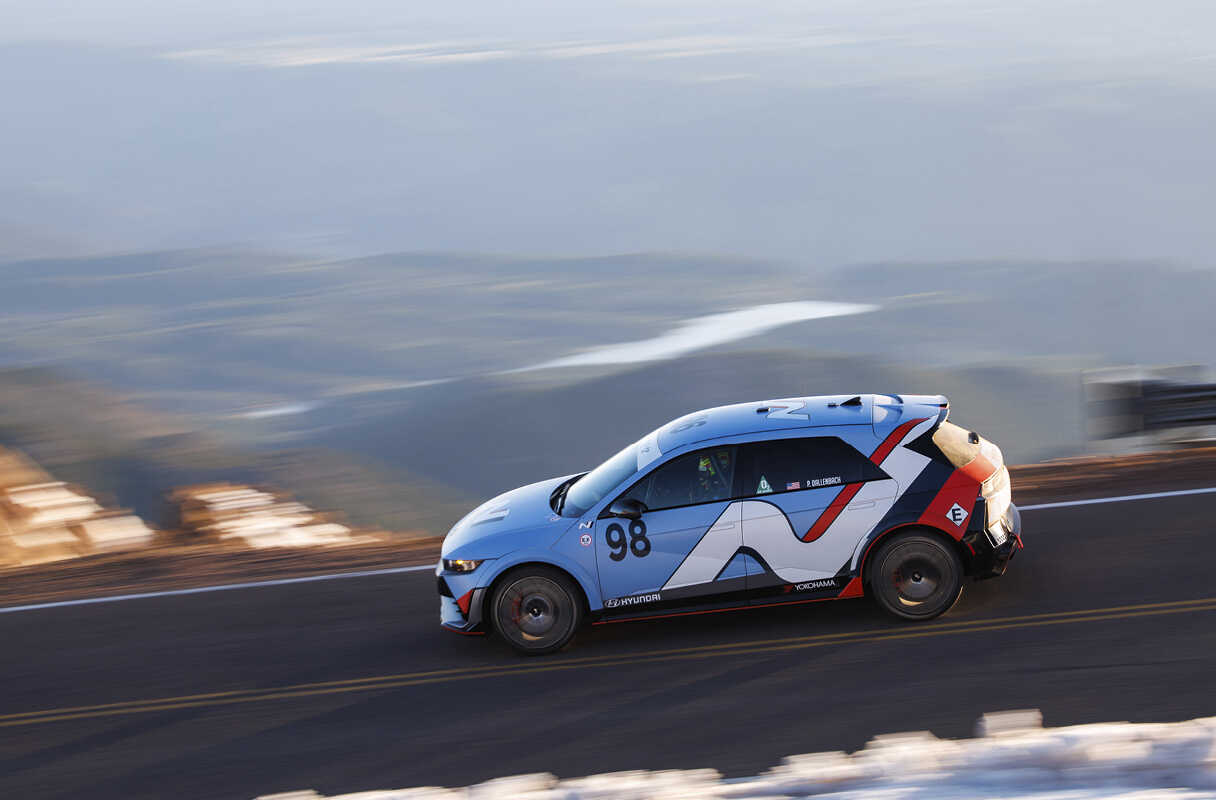 Side view of vehicles speeding along the Pikes Peak course