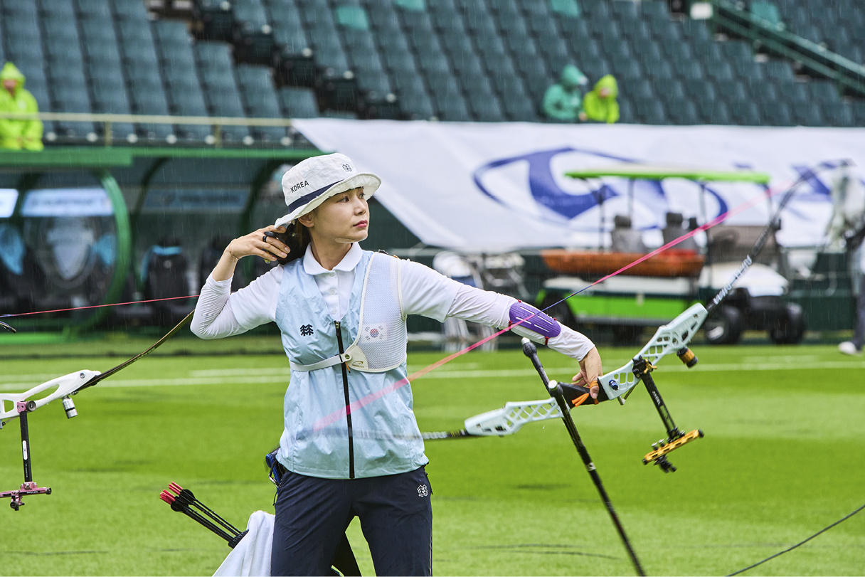 the sight of a female archer shooting a bow