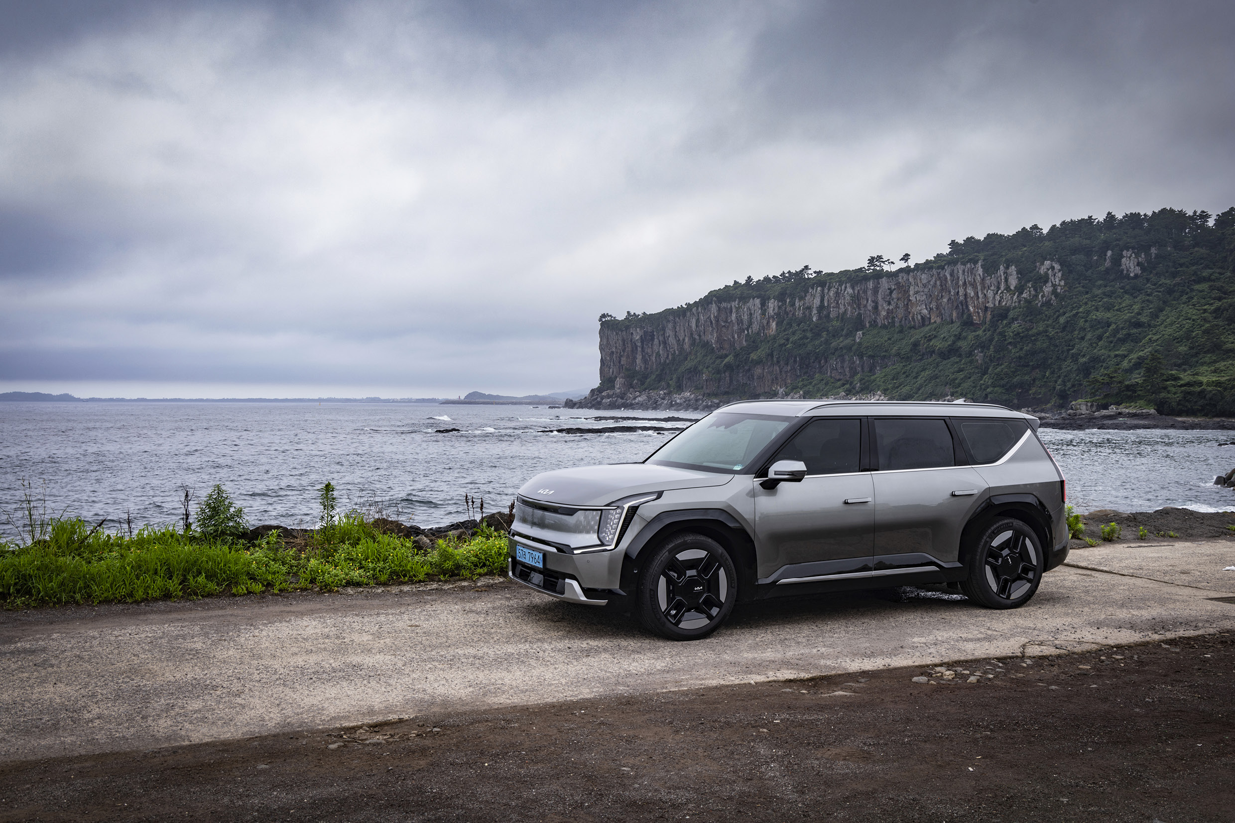 A front view of a gray SUV stopping by the sea