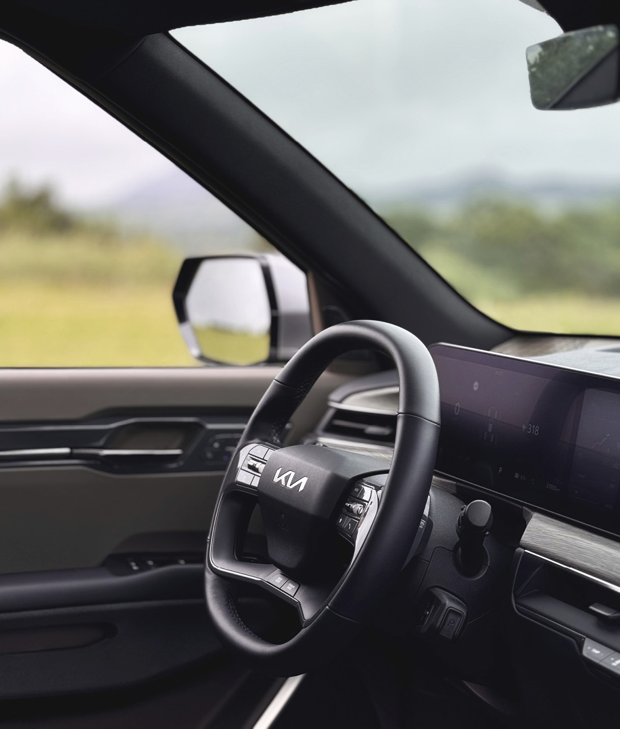 The steering wheel of the EV9 is reflected diagonally