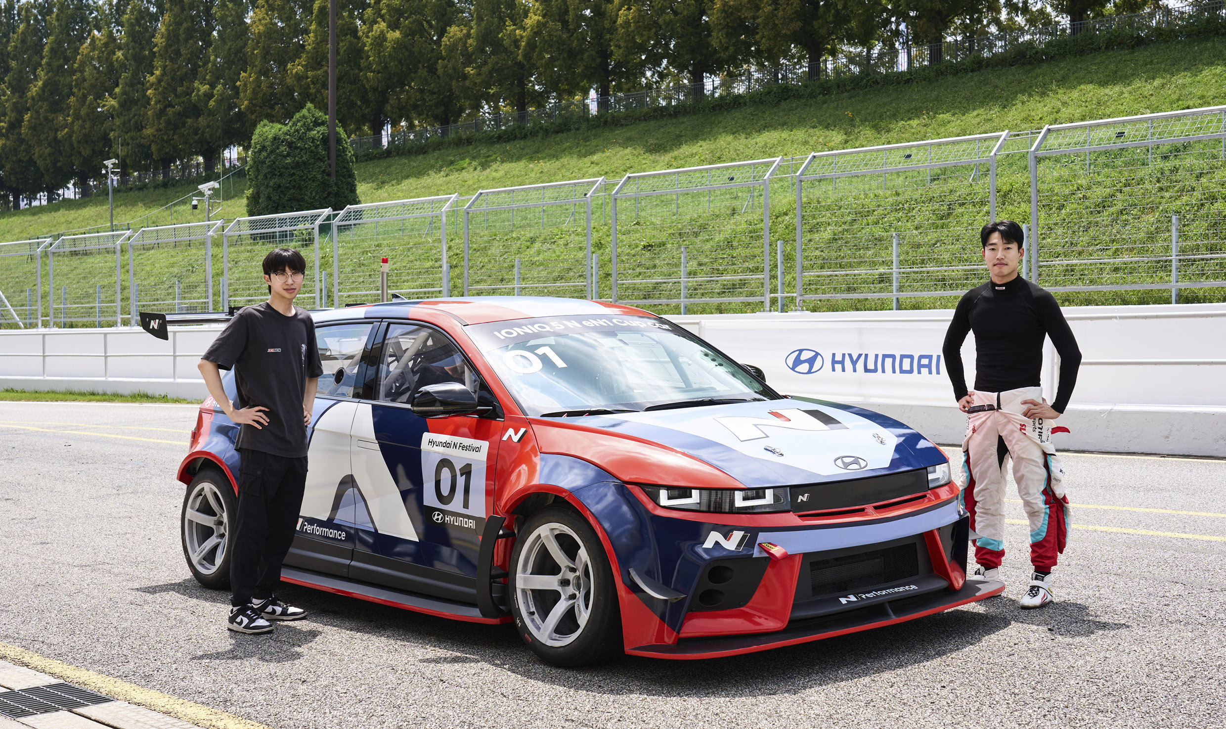 A race car and two drivers on the track