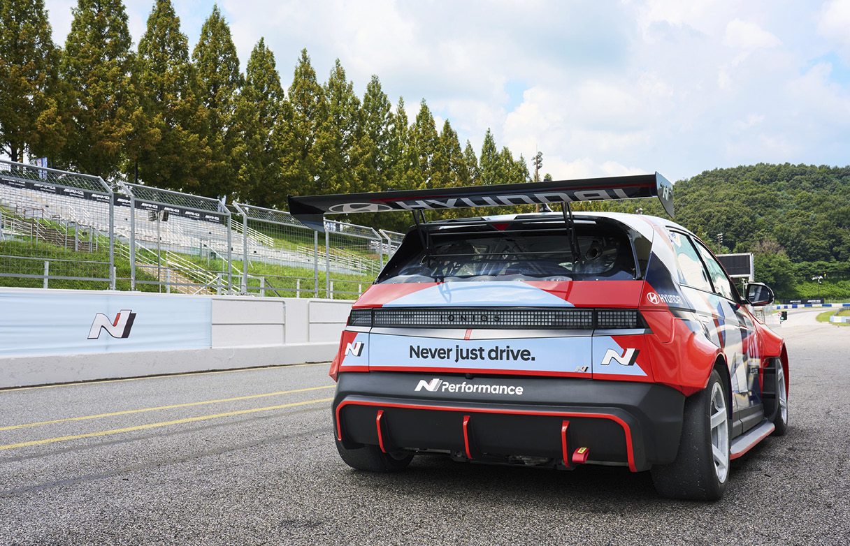the rear side of a race car standing on the track