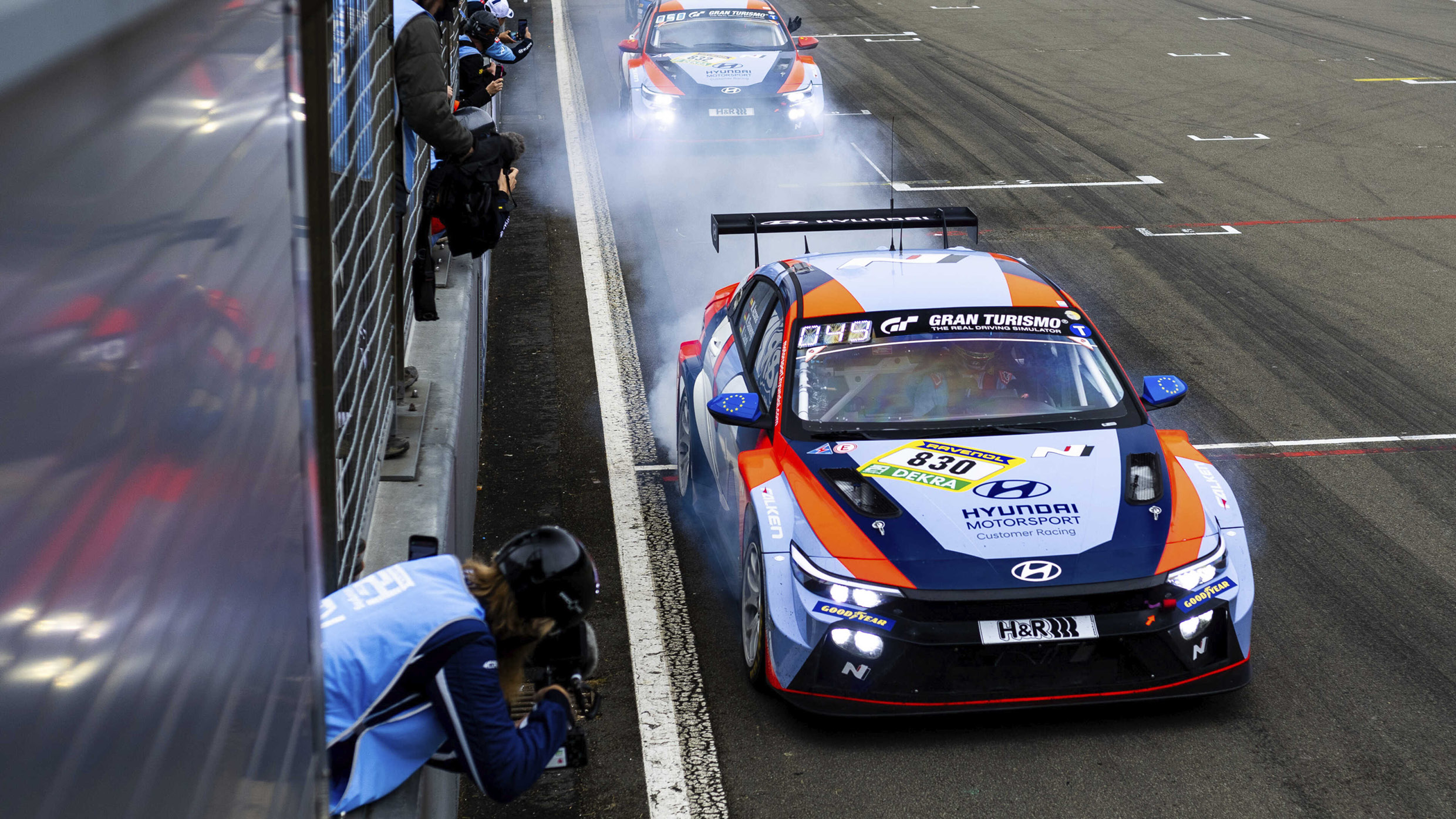 The race cars getting ready to start with a lot of smoke