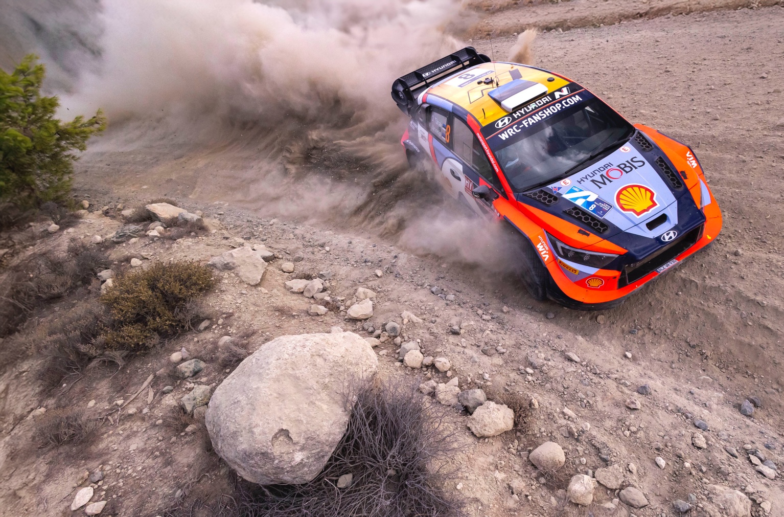 The rally car is running on a rough road