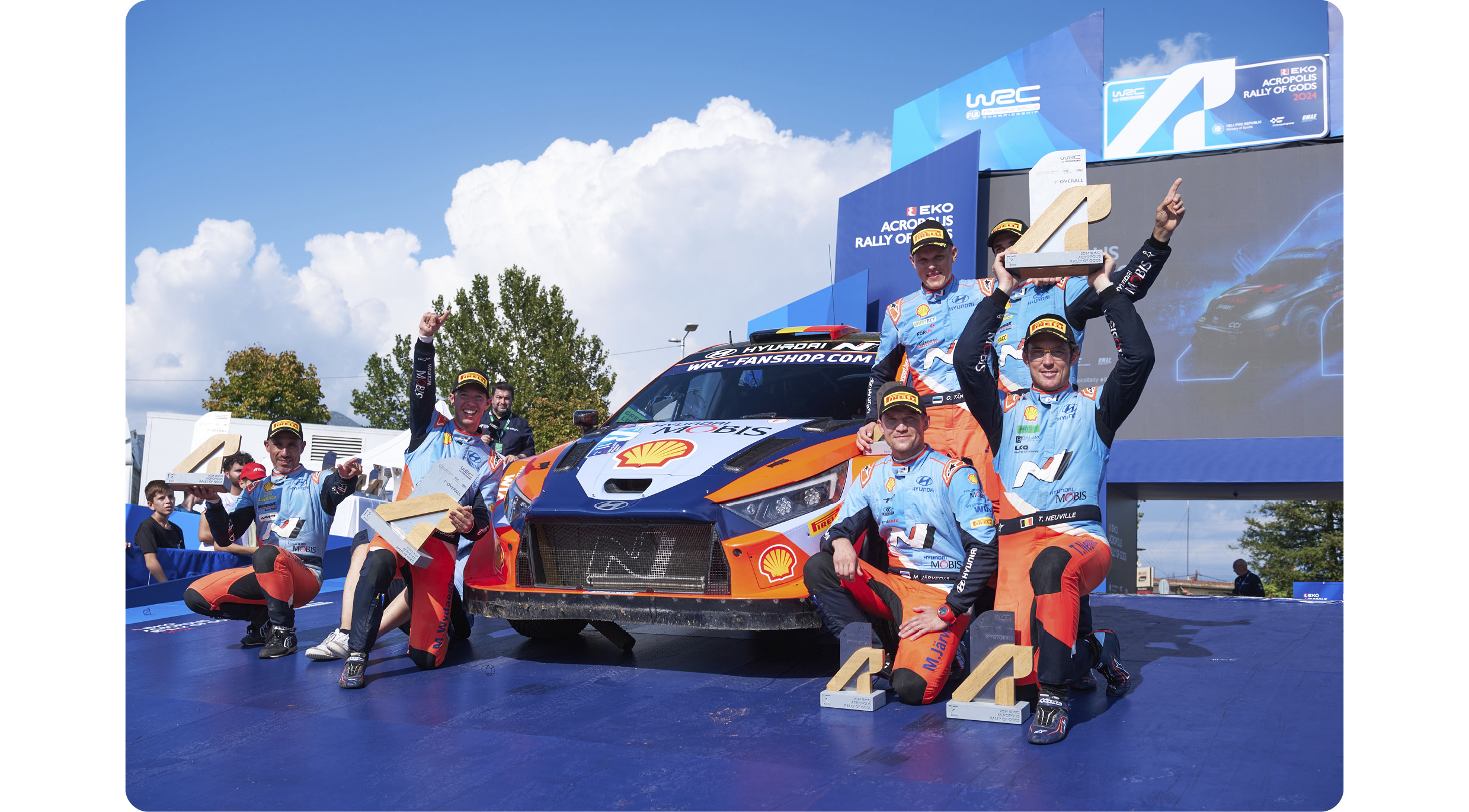 The driver is happy to win the trophy