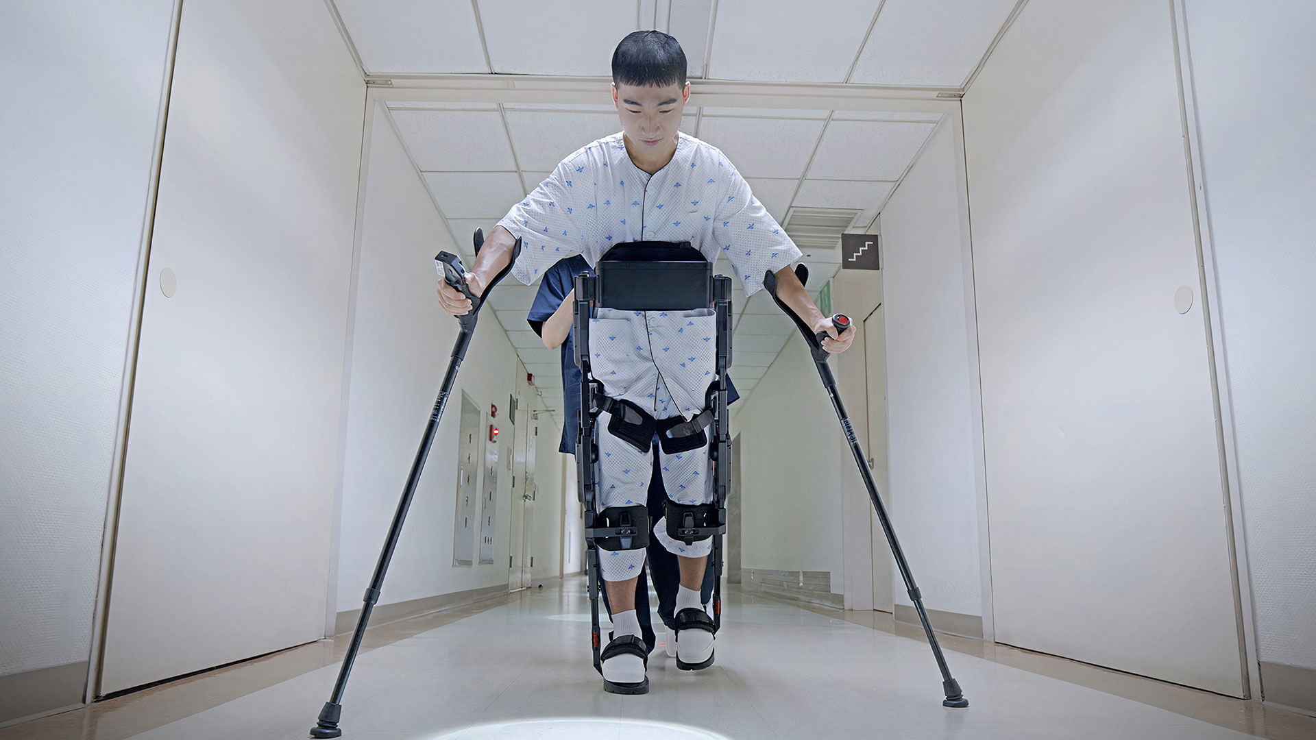 ‘엑스블 멕스’ 재활 로봇을 활용해 병원 복도를 걸어가는 부상 군인의 모습
