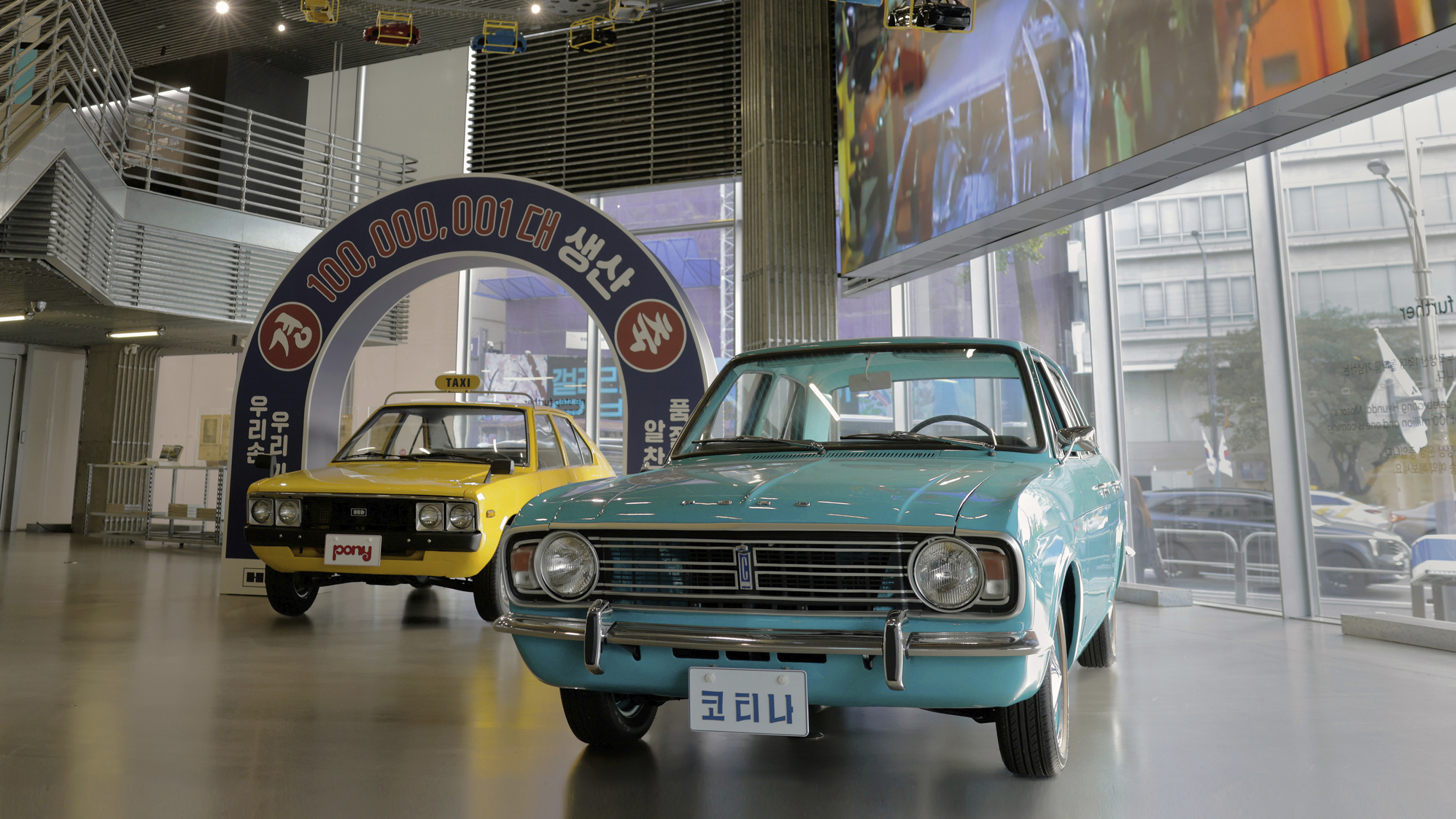 Green car and yellow car are stand diagonally