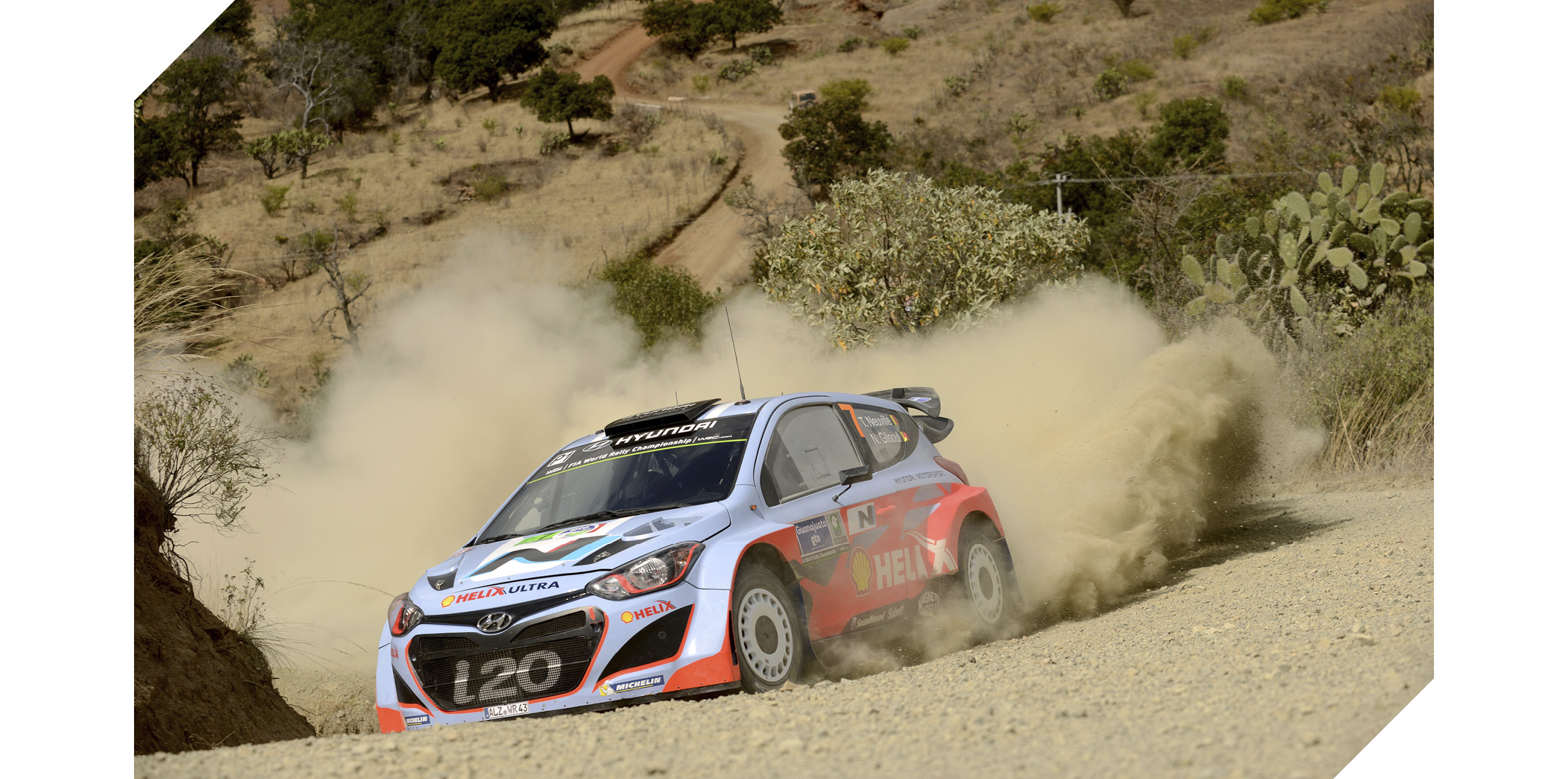i20 rally car turning a corner flying dirt dust
