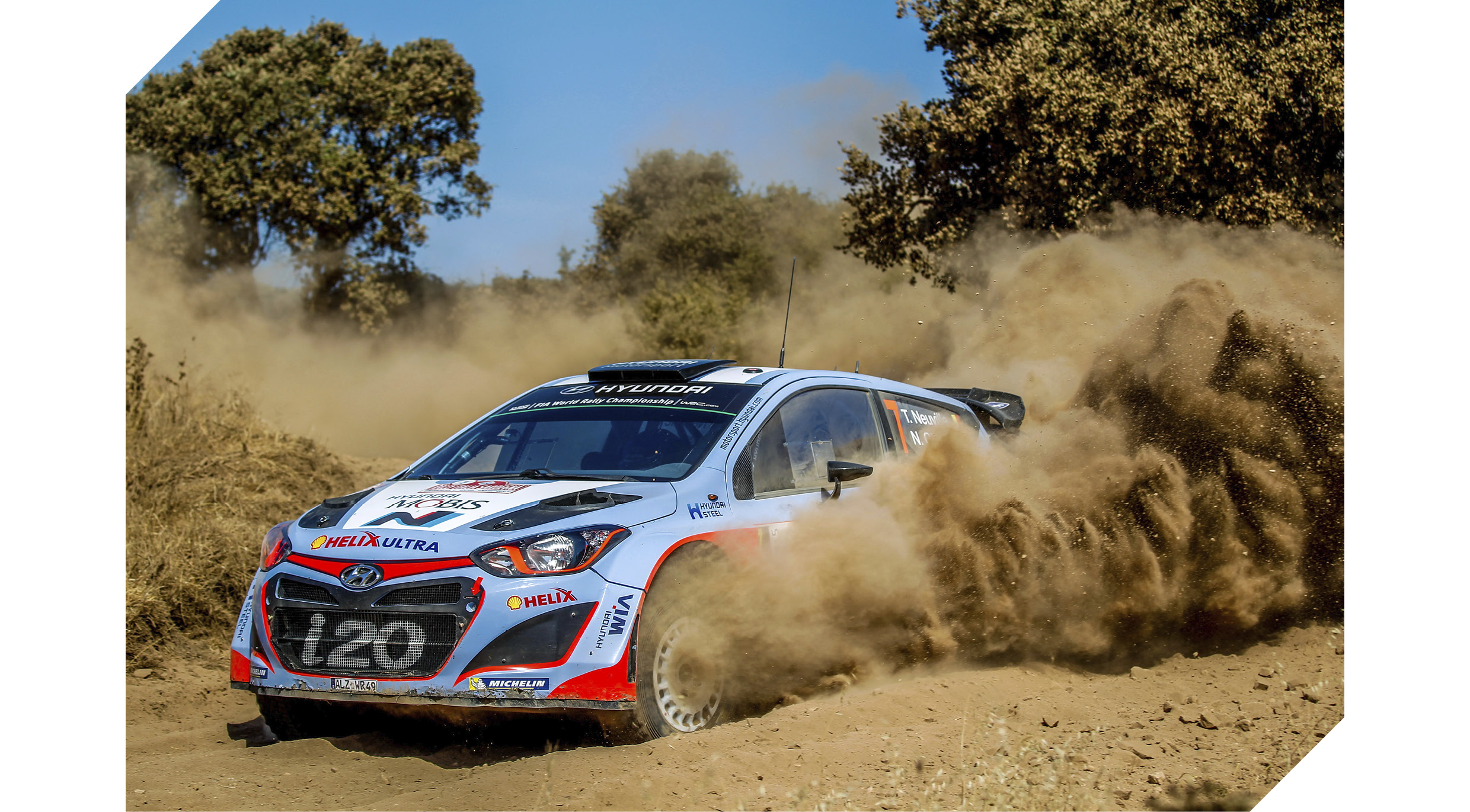 i20 rally car turning a corner flying dirt dust