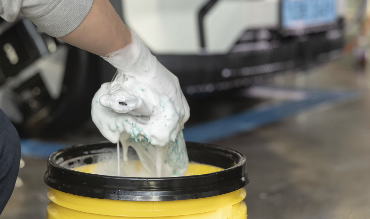 Putting car shampoo on the wash pad
