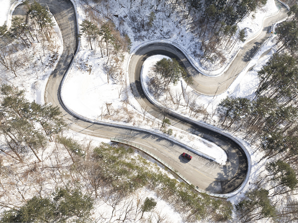 Filming with a drone on the winter winding road
