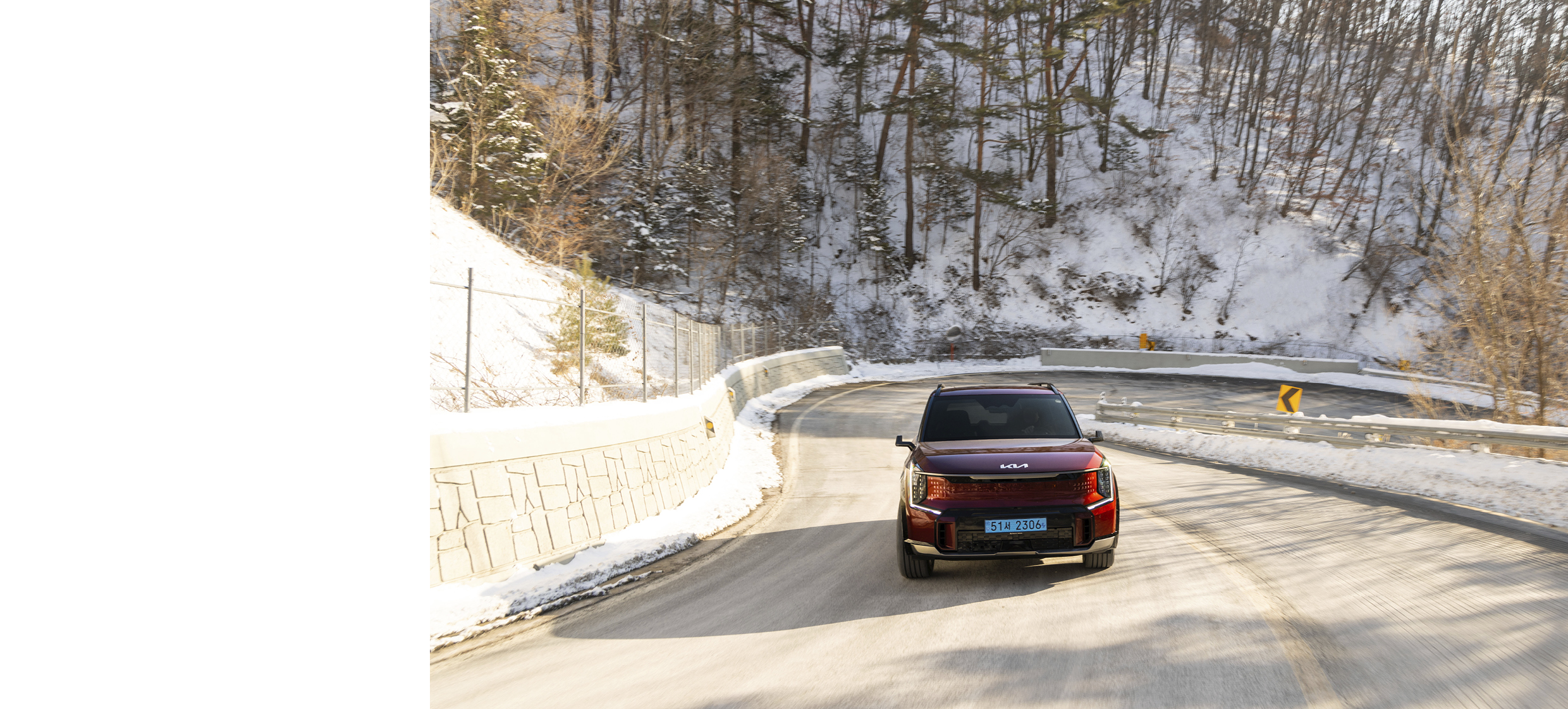 겨울 굽잇길을 달리는 기아 EV9의 모습