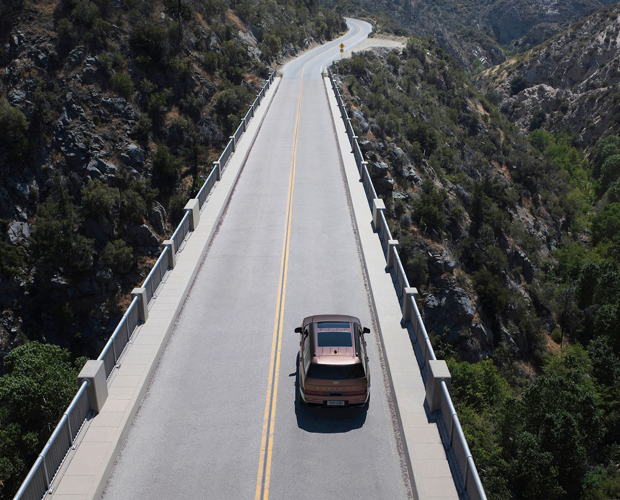 산악 도로를 주행하는 SUV 후면 모습