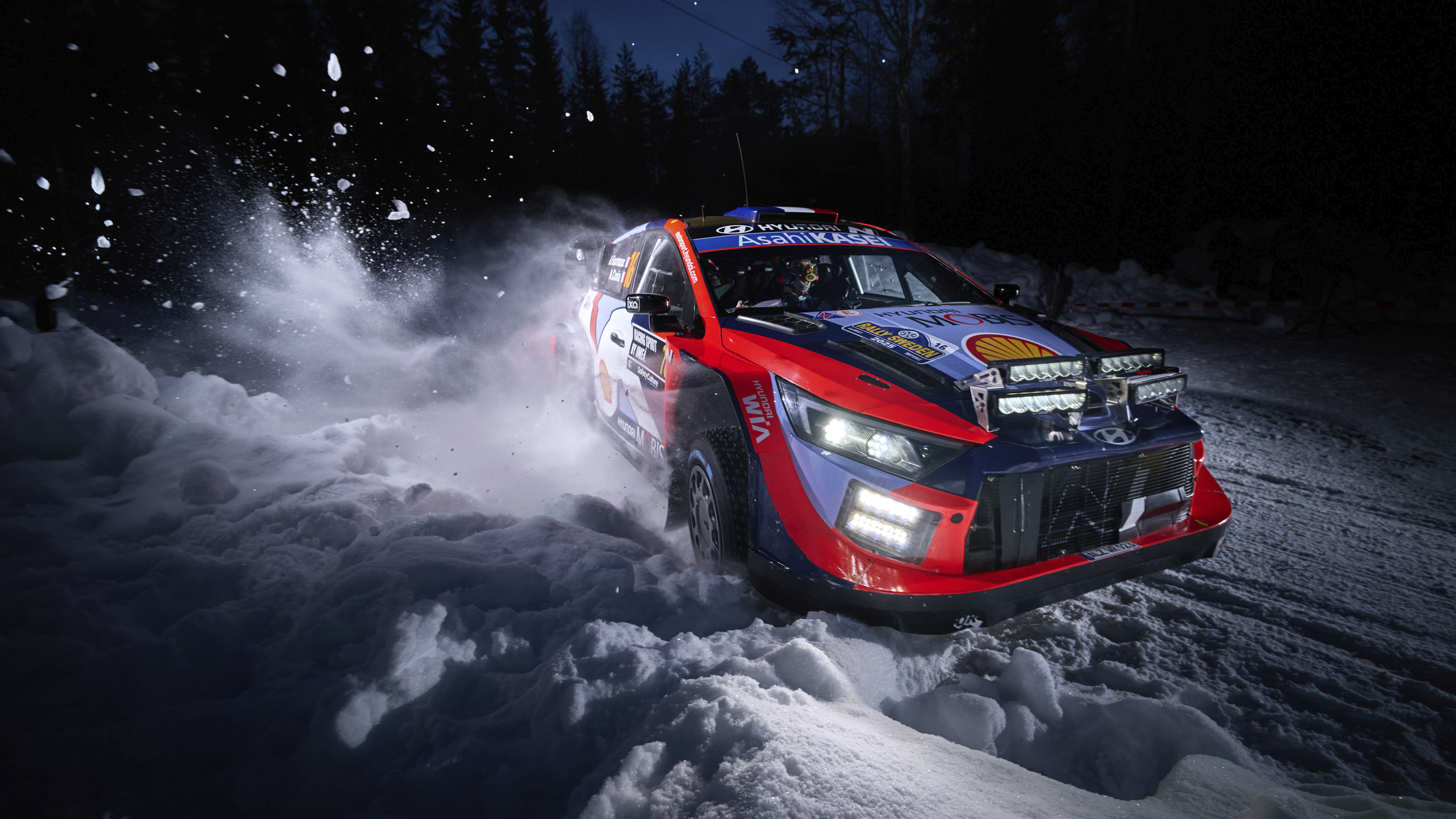a rally car running through the snow