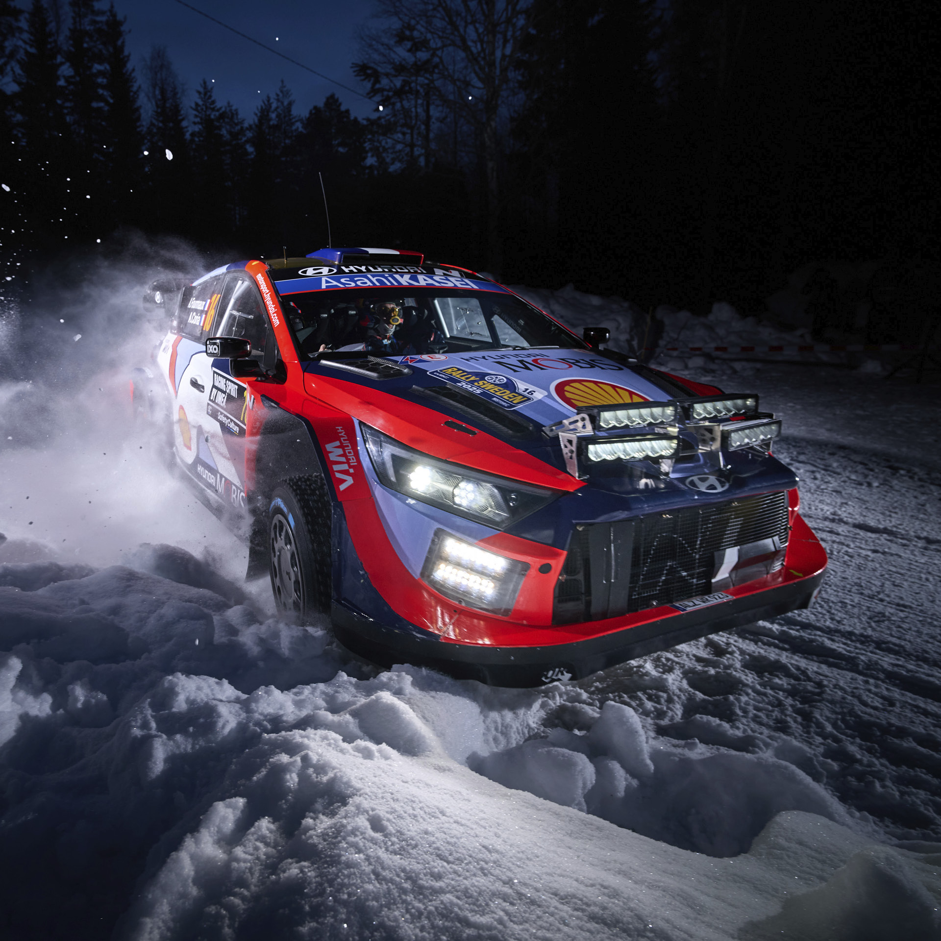 a rally car running through the snow