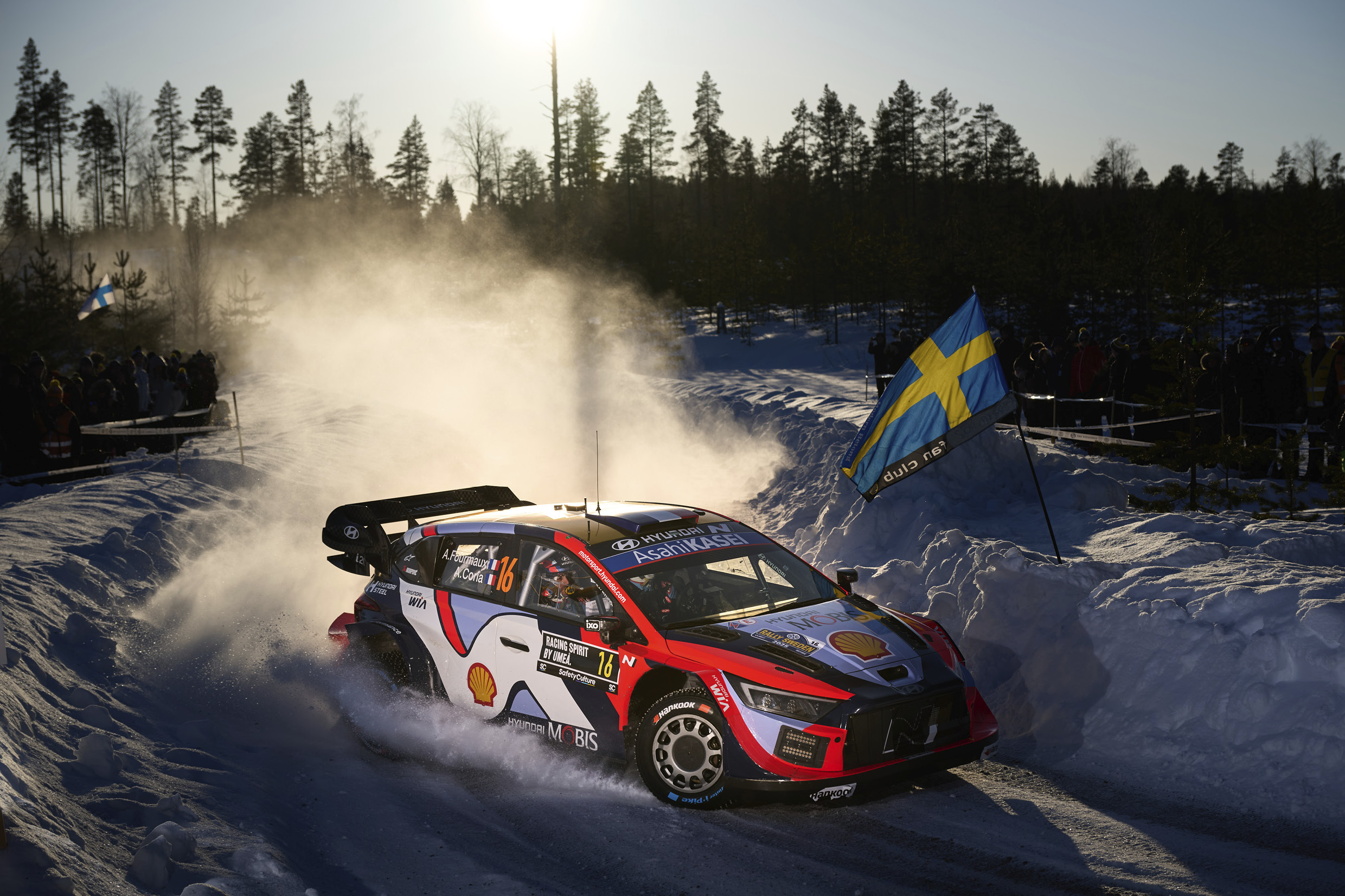 a rally car running through the snow