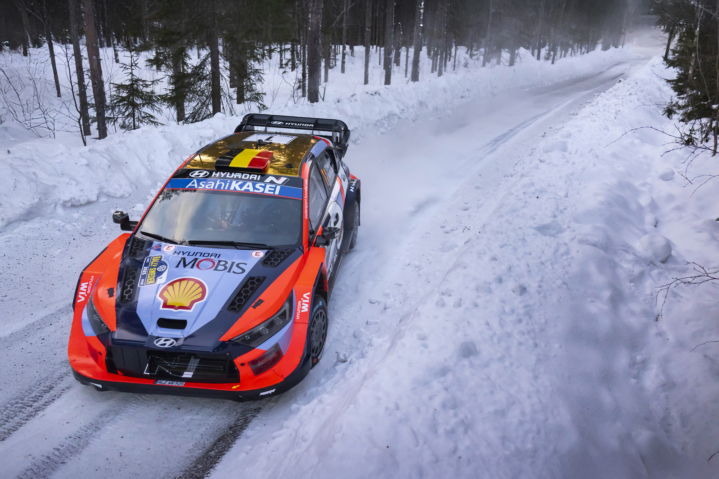 a rally car running through the snow