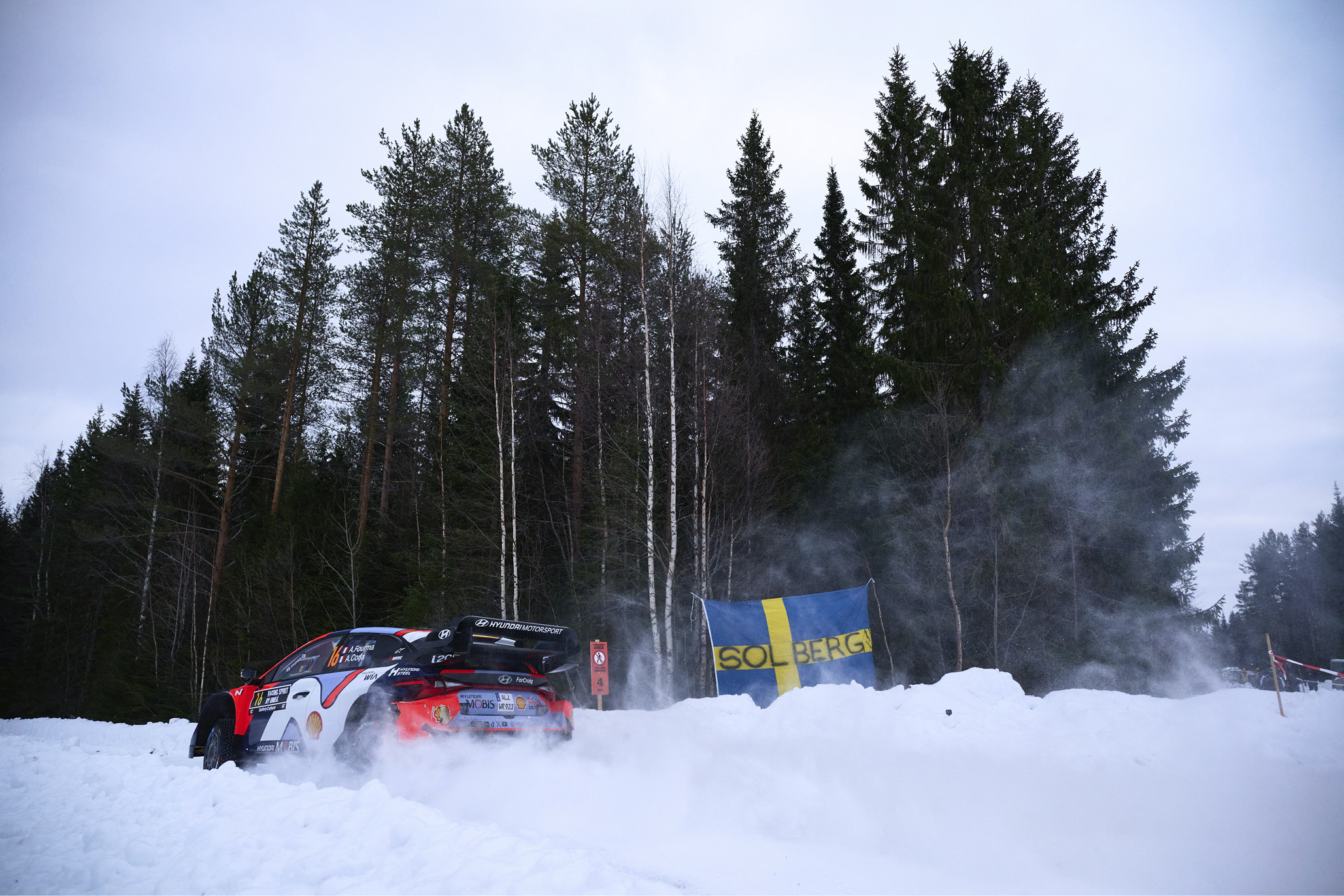A rally car runs over the snow