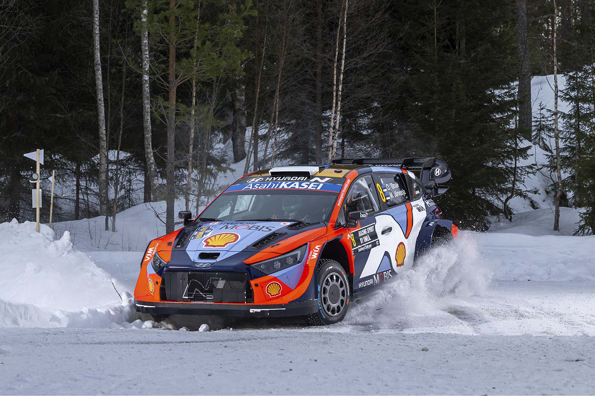a rally car running through the snow