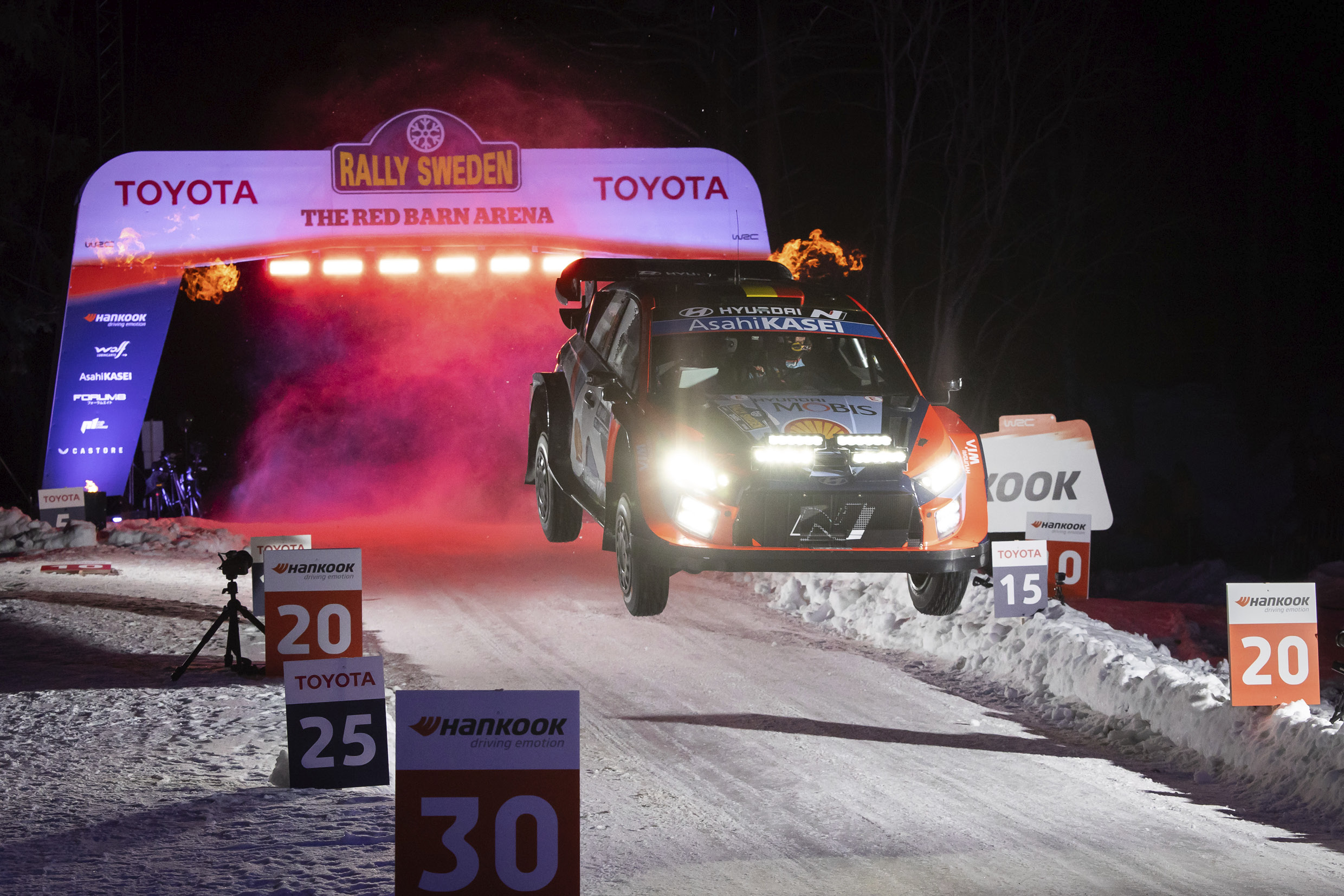 a rally car makes a big jump
