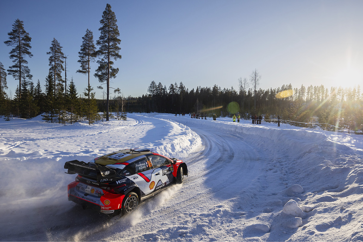 a rally car running through the snow