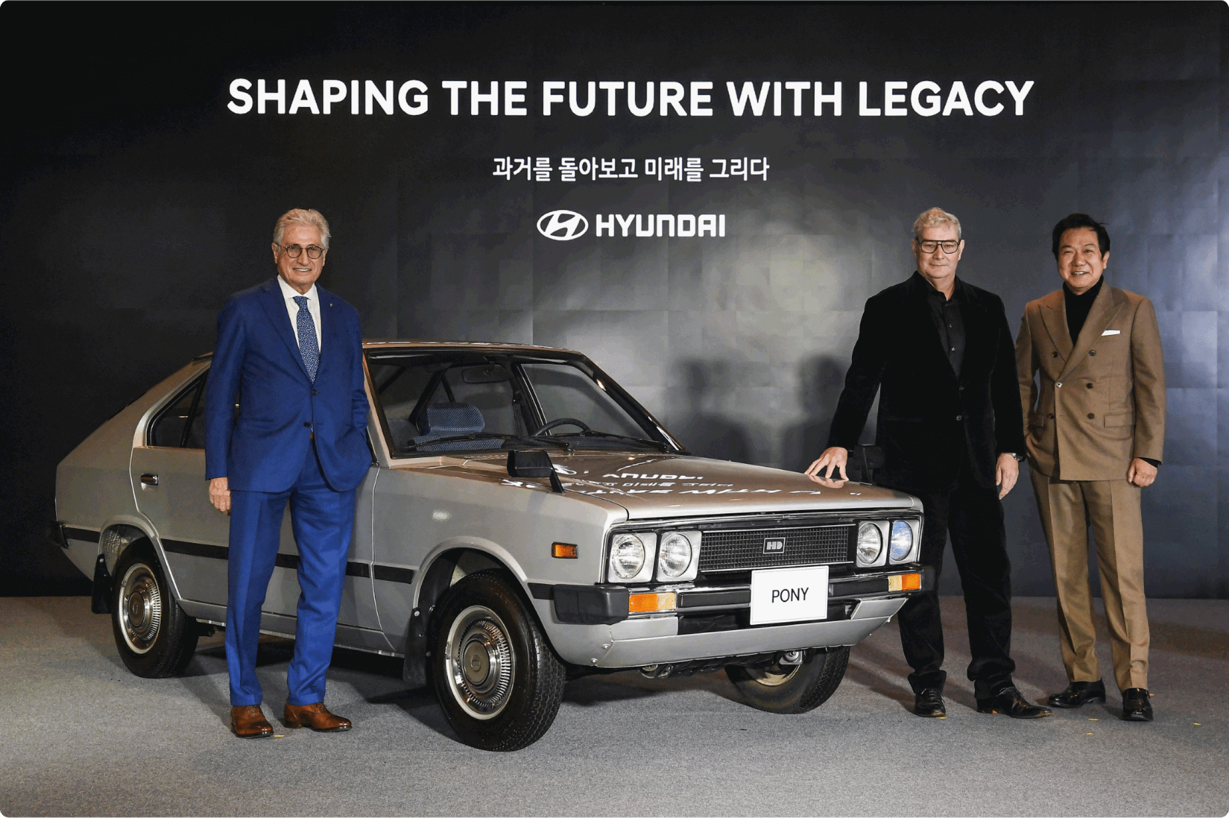 The car designers standing with Pony
