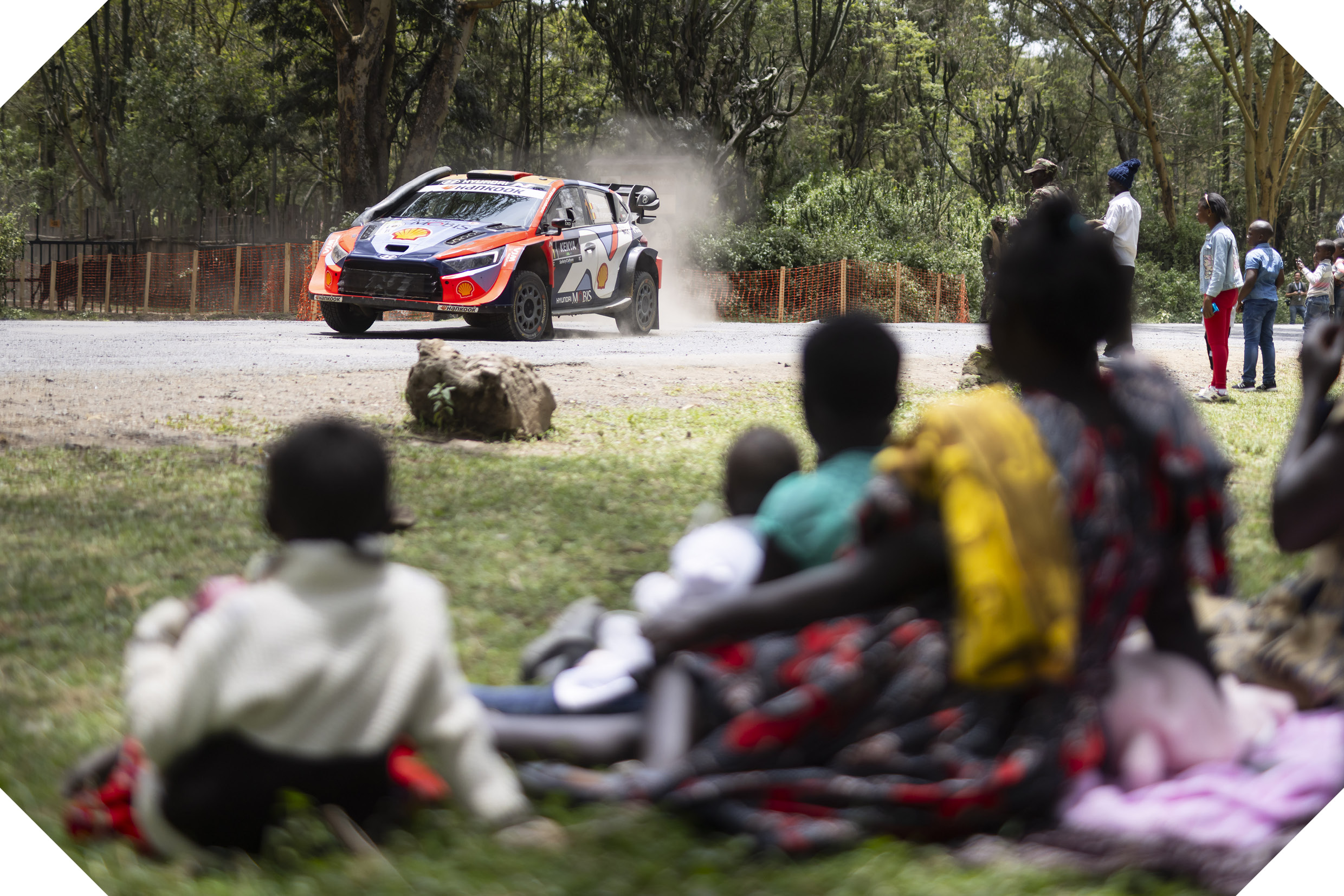 spectators watching the rally car pass by