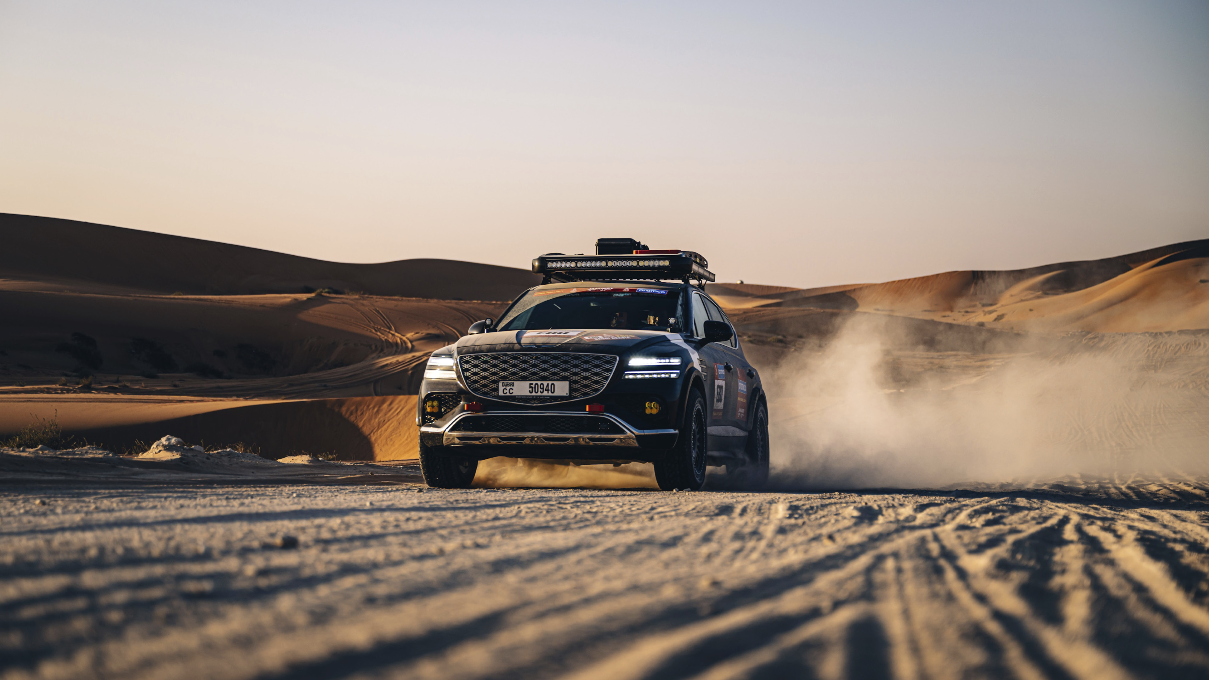 The image of GV80 racing through the desert